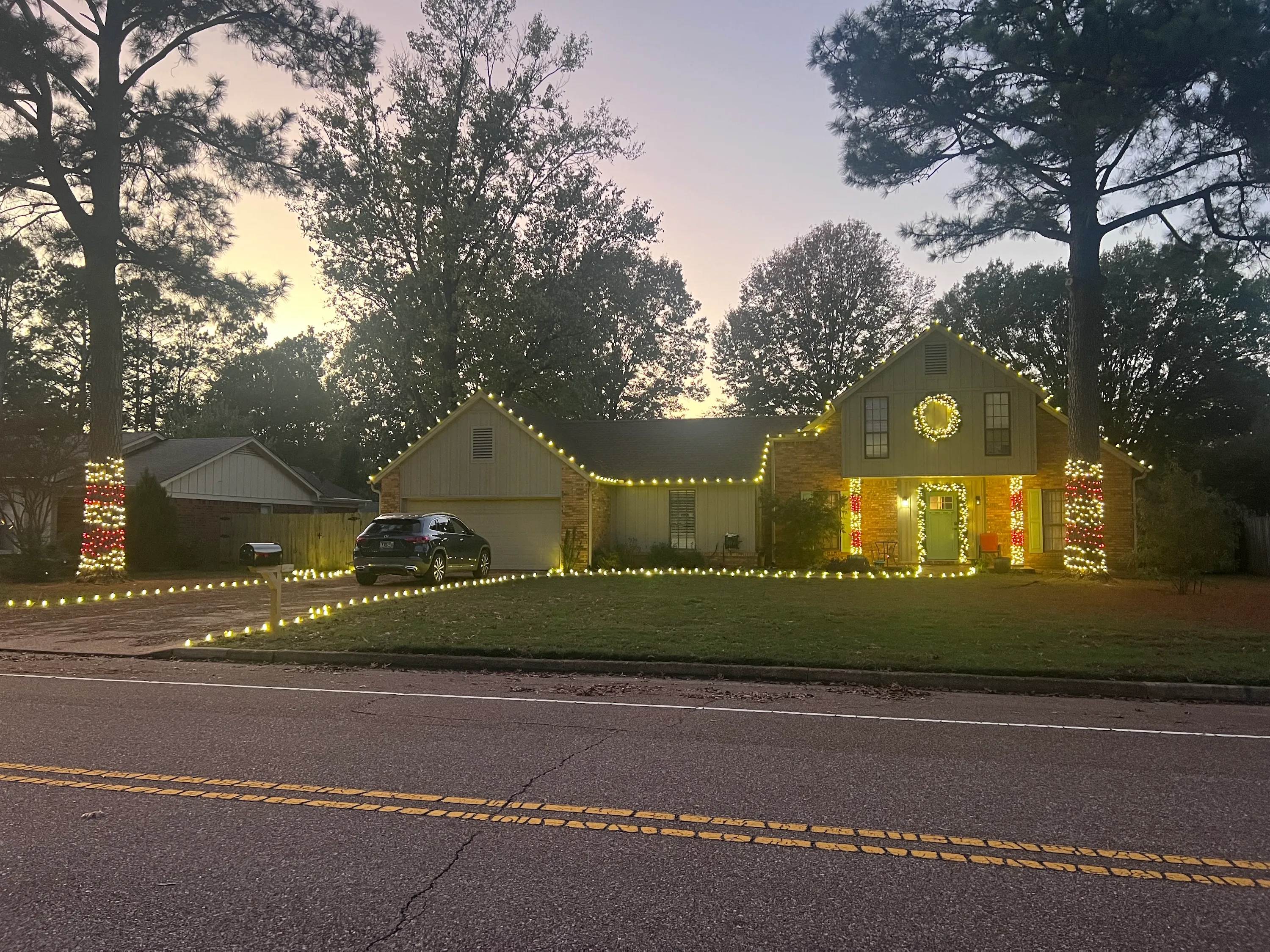 Home with holiday lighting at dusk