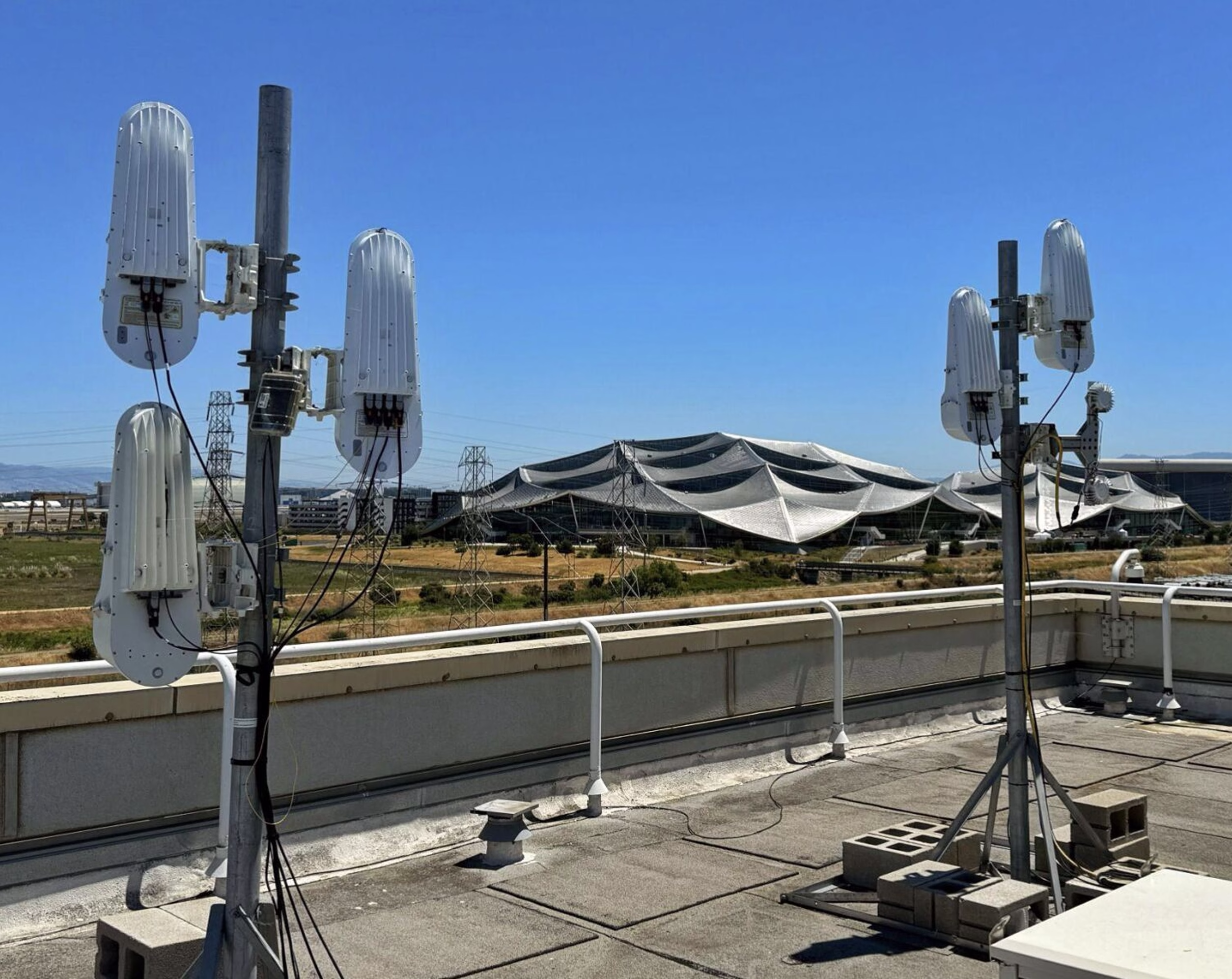 LightBridge units installed on rooftop mounting poles against a clear sky
