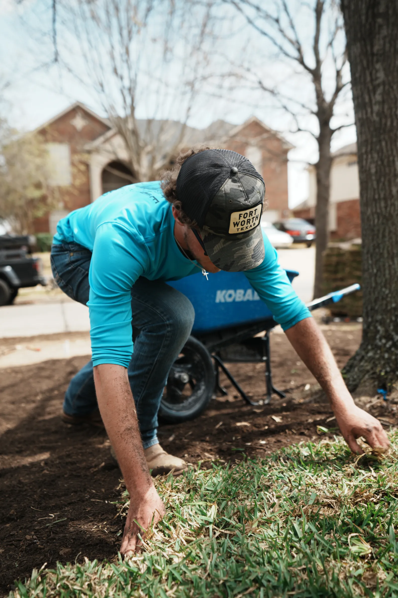 Sod installation in Mansfield, TX with fresh sod being laid by hand