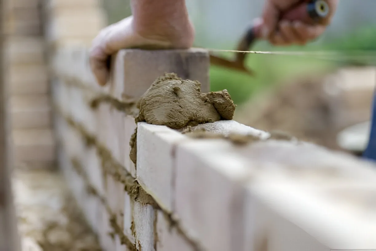 Paver patio and hardscaping contractor applying mortar during a Mansfield, TX masonry project