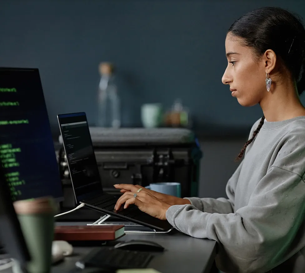 Developer working at a multi-monitor workstation