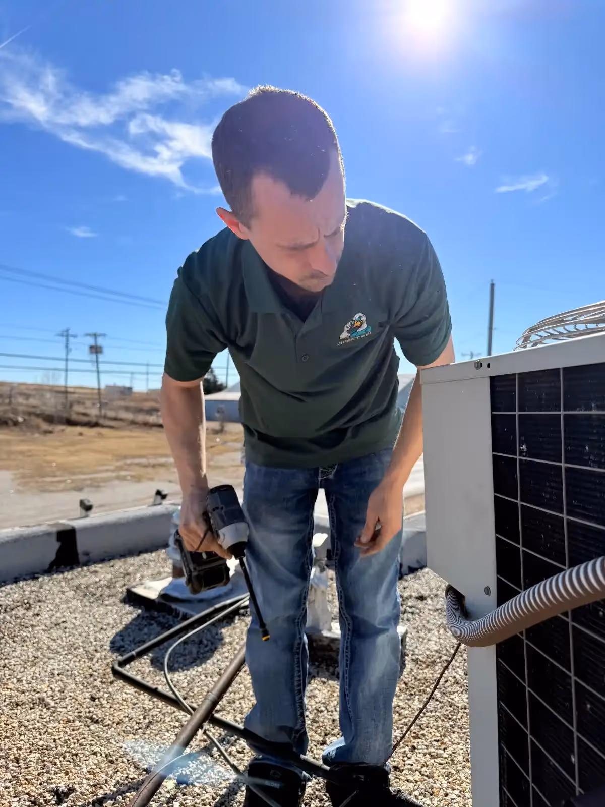 Technician working on solar panel equipment on a rooftop