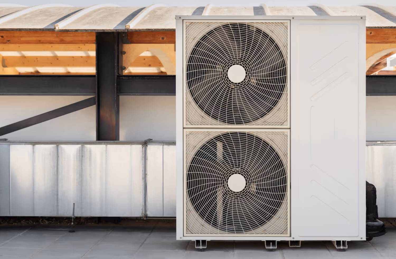 Large dual-fan air conditioning unit mounted on building exterior