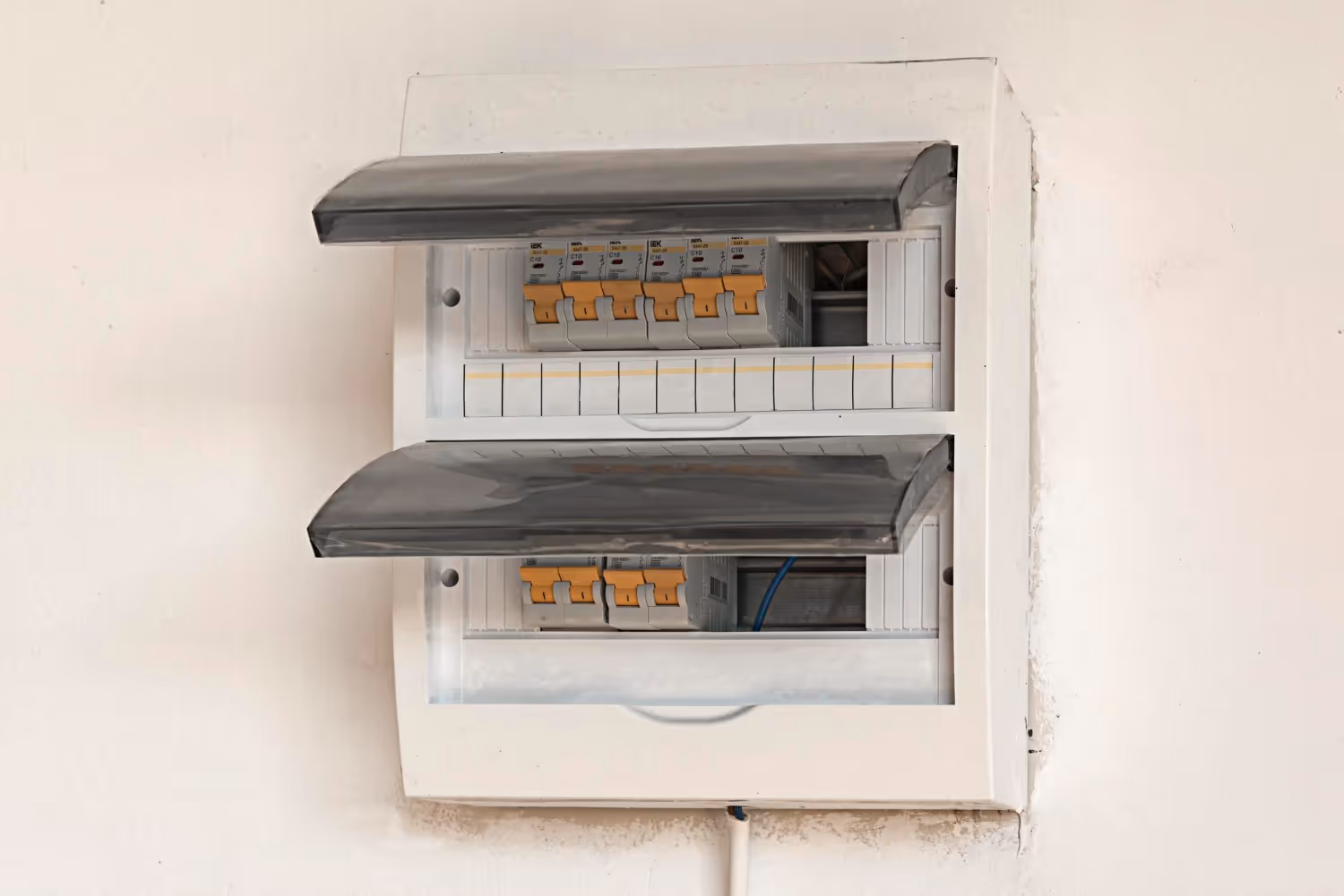 Electrical distribution board with circuit breakers mounted on white wall