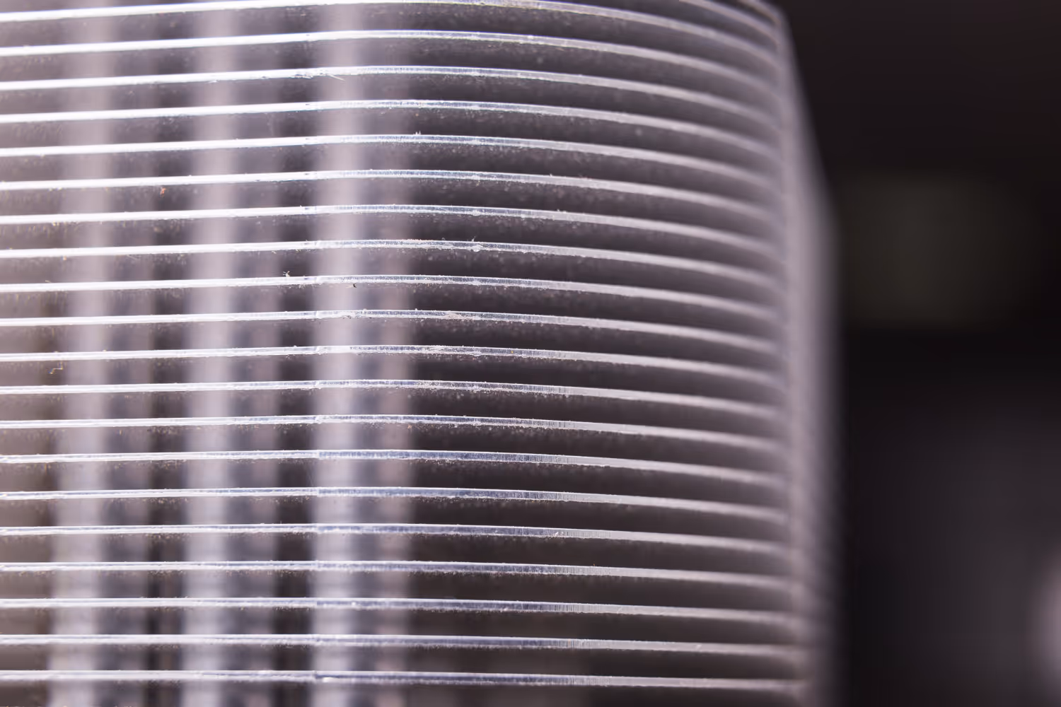 Closeup of metallic ribbed surface with repeating horizontal lines
