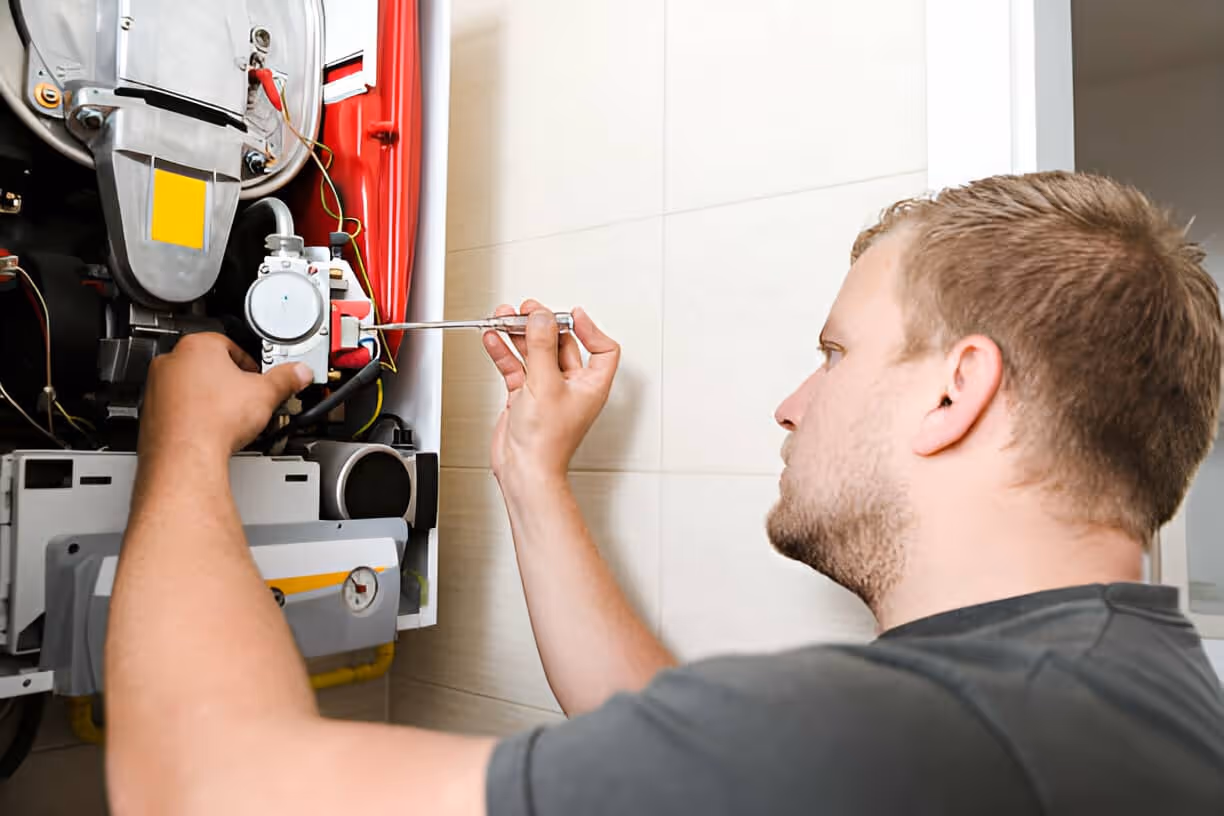 Technician repairing electrical panel with screwdriver in residential setting