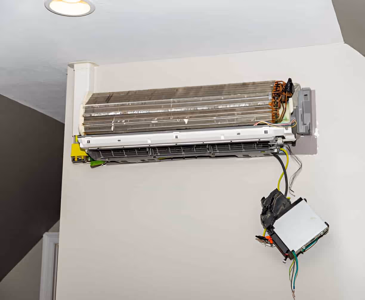 Dismantled air conditioning unit with exposed internal components