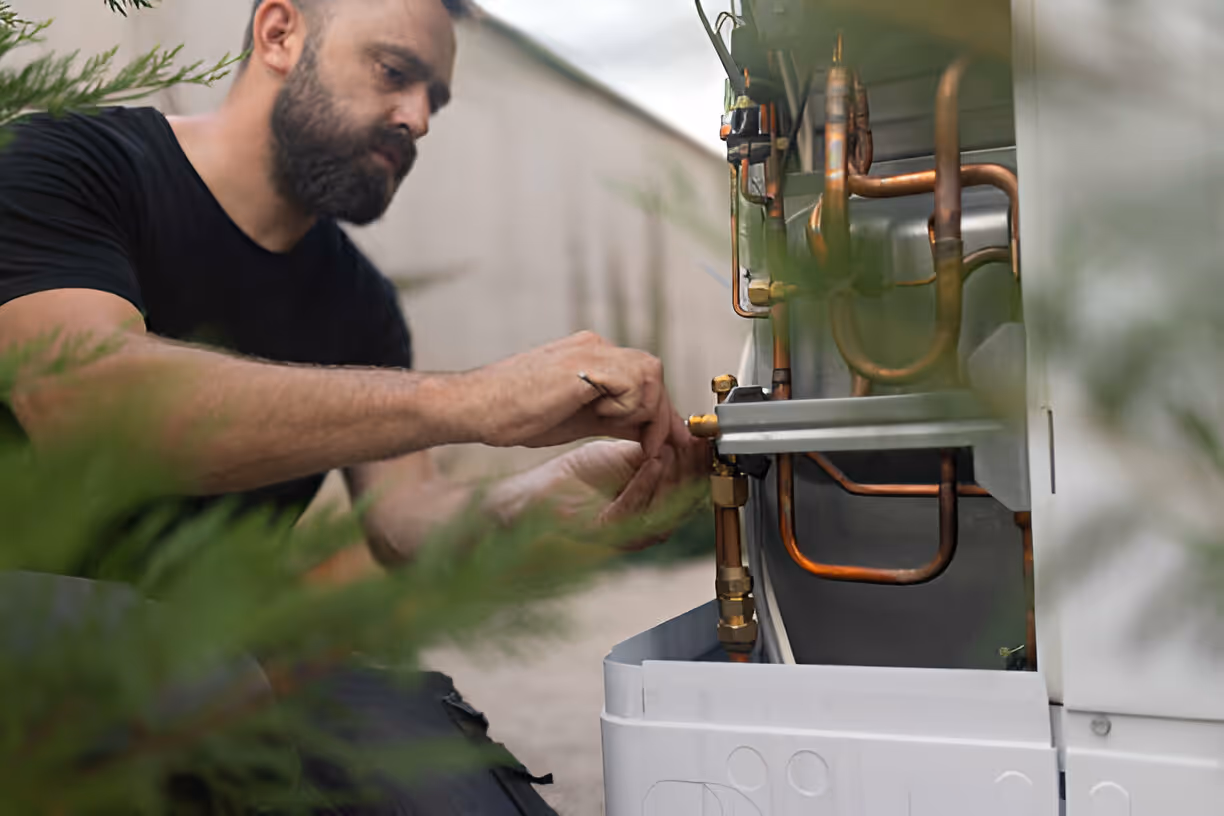 Technician working on copper pipes of an HVAC or heating system