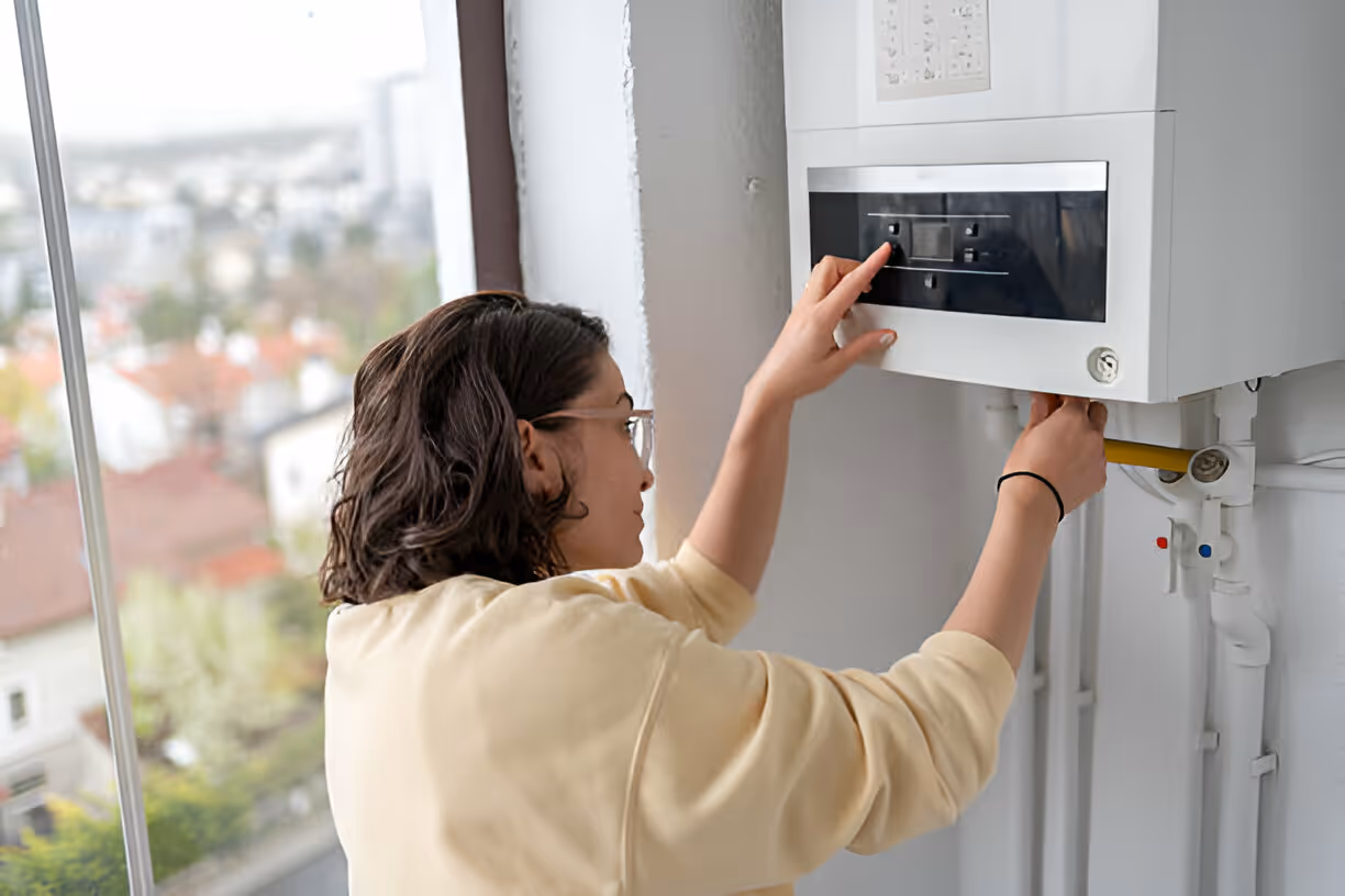 Person adjusting control panel near window with cityscape view