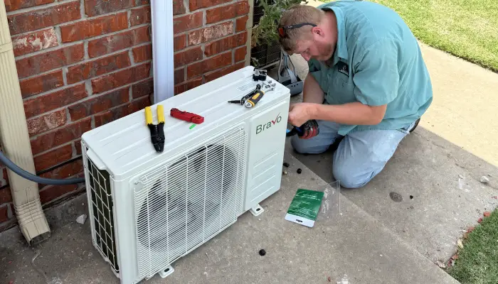 White wall-mounted air conditioning unit with digital display
