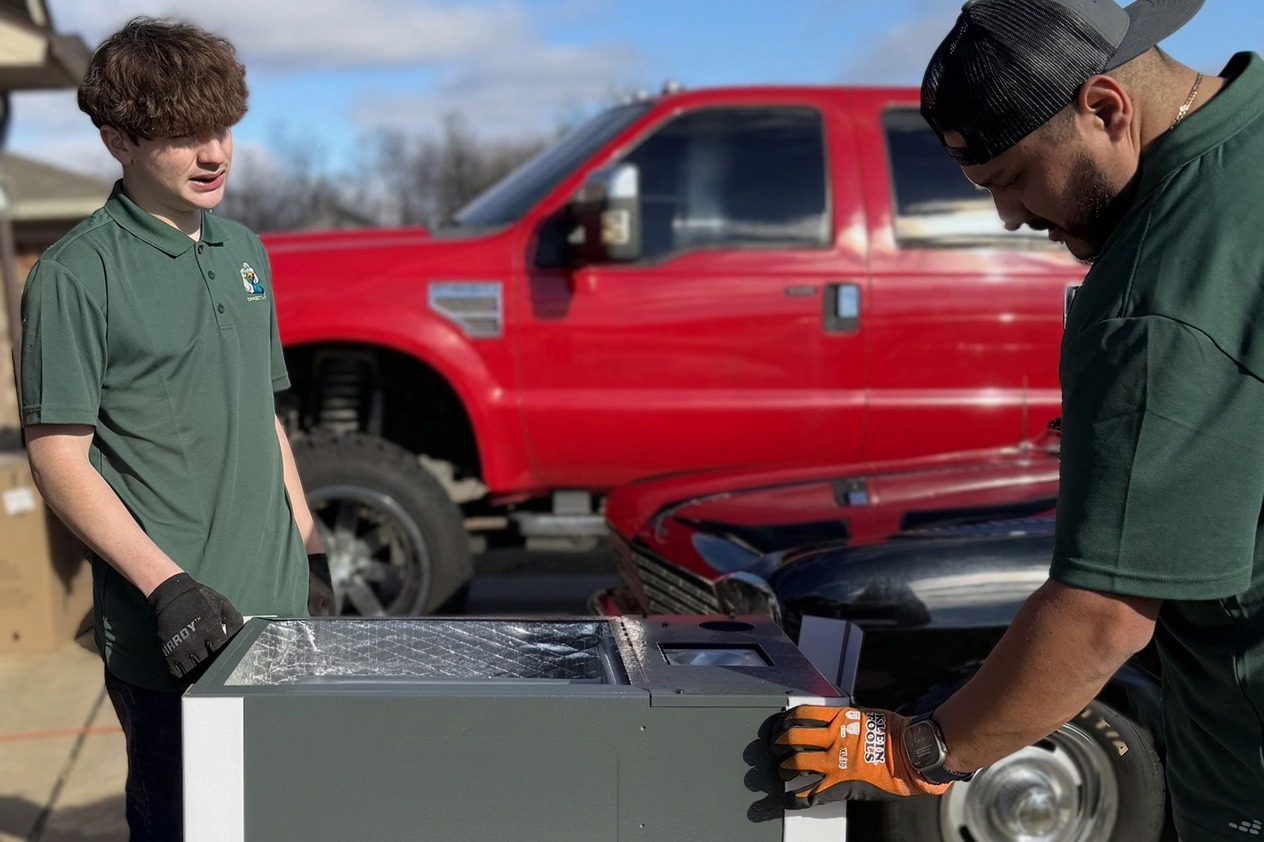 Direct Air technician inspecting a residential AC unit in Oklahoma City