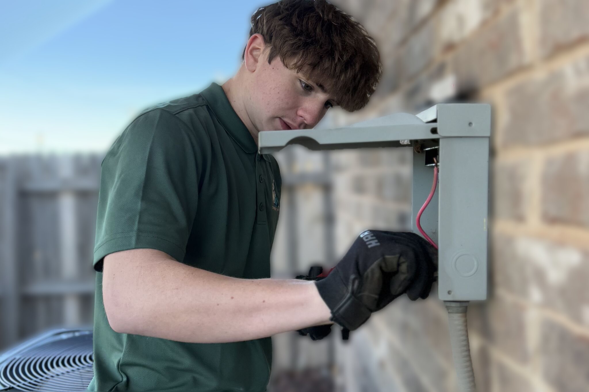 Direct Air technician inspecting an aging AC condenser at an Oklahoma City home