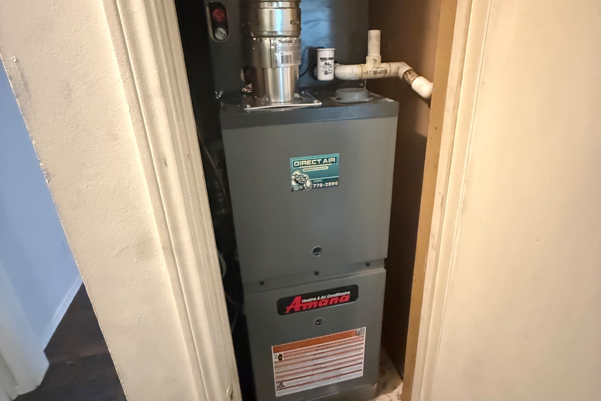 Direct Air technician installing indoor HVAC equipment in an Oklahoma City home