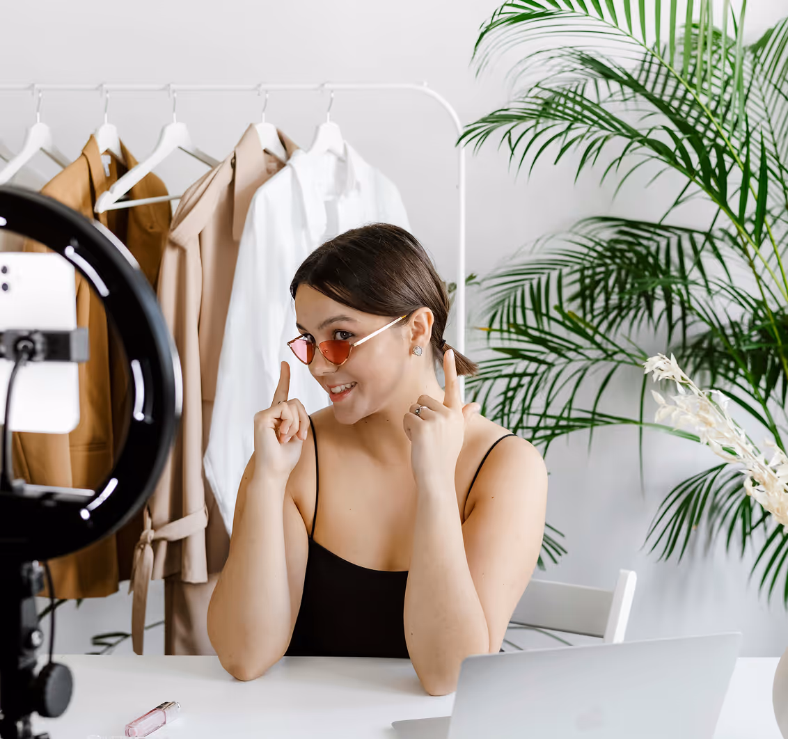 Fashion influencer filming product content with ring light, showcasing Kicksti’s support for creators in reaching wider audiences.