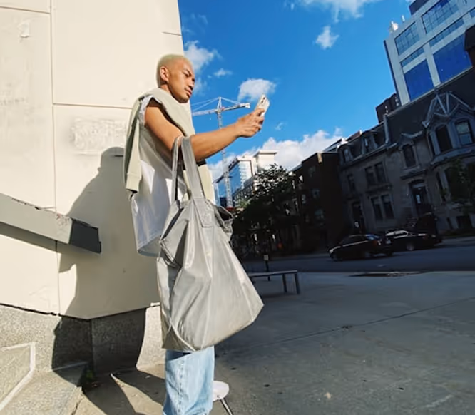 Fashion-forward content creator taking a selfie in an urban setting, highlighting street style and mobile-first Instagram engagement with Kicksti.