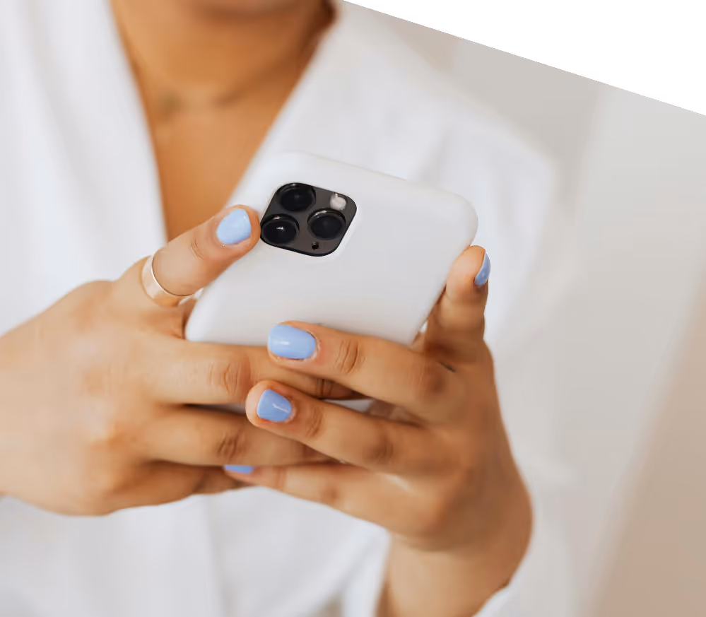 Close-up of woman using smartphone with focus on hands and modern design, representing mobile-friendly growth features of Kicksti.