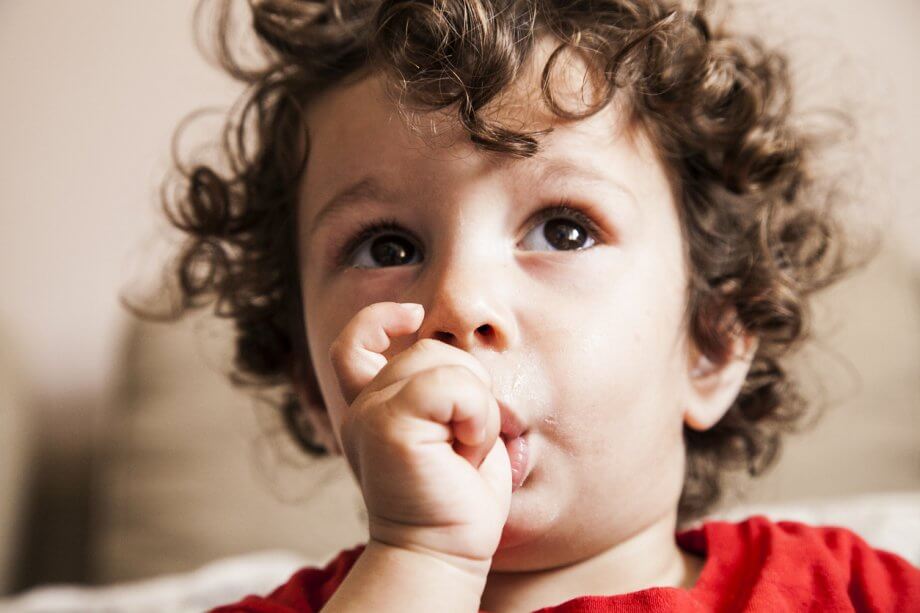 A kid sucking his thumb