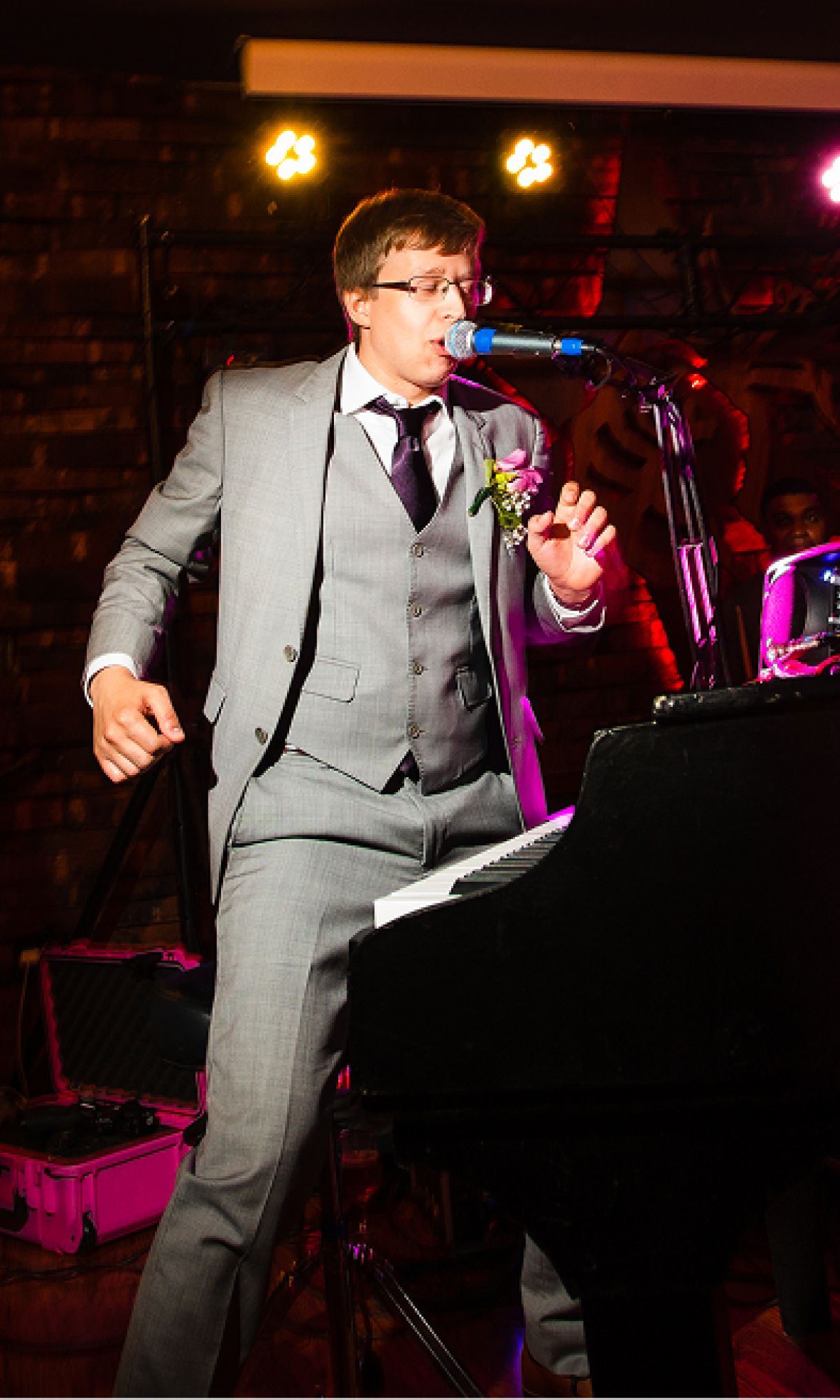 Four musicians playing instruments on a stage under warm lighting