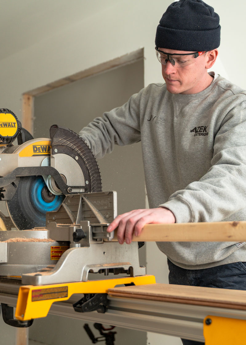 A JWDB craftsman at work inside a custom living space in the Portland Maine area