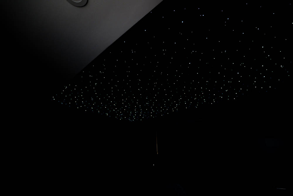 Custom home theater with starry night lit ceiling in basement remodel by JW Design | Build