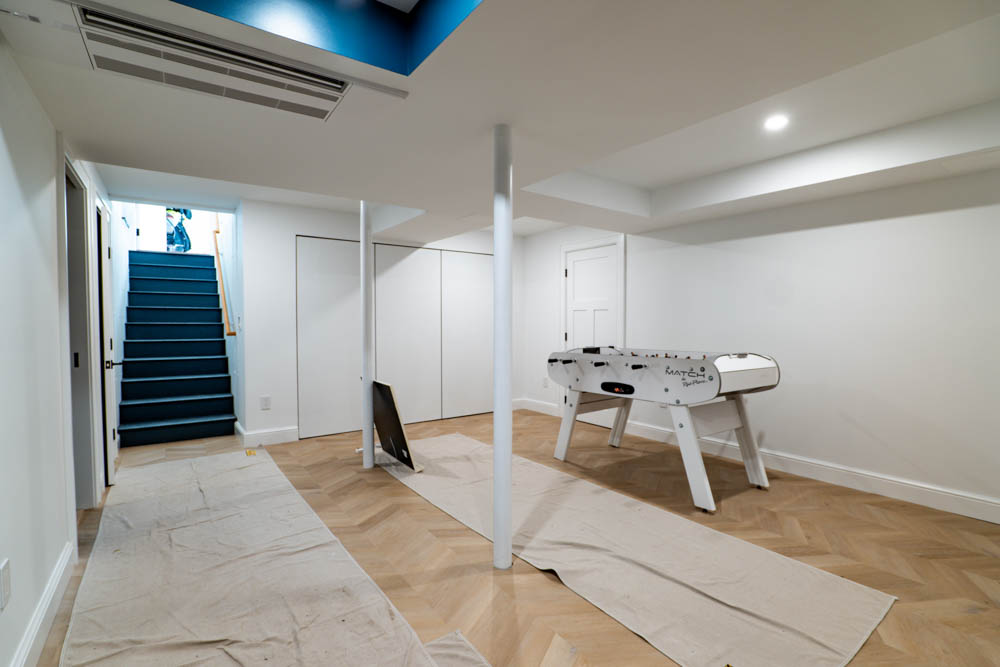 Entertaining space and foosball table in basement remodel by JW Design | Build