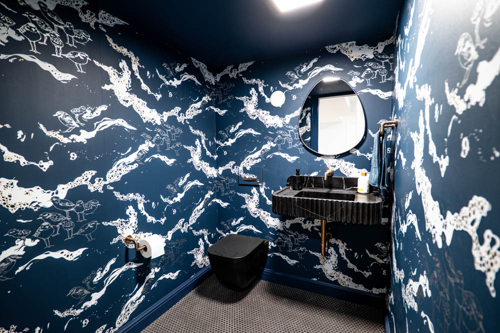 Half bath with sea inspired wall design in basement remodel by JW Design | Build