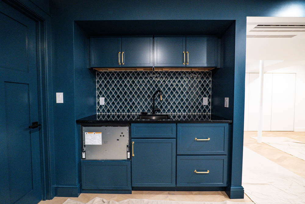 Sink and utility counter with storage in basement remodel by JW Design | Build