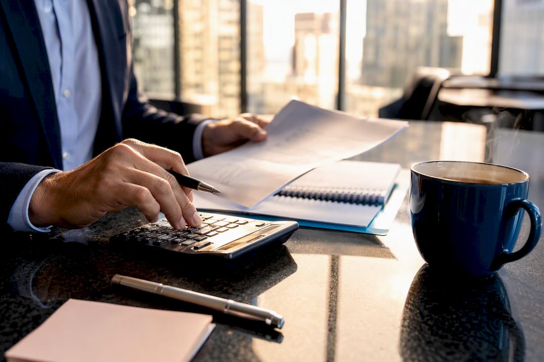 Hands calculating business credit factors