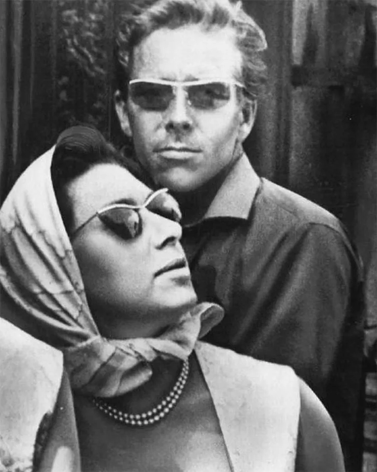 Princess Margaret, fashion icon of the sixties, seen with Peter Townsend. The princess wears a scarf tied around her hair and neck, along with vintage Solamor sunglasses.