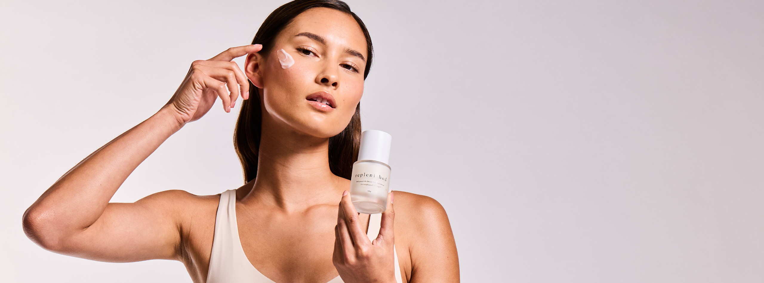 Woman applying Precision Skincare serum