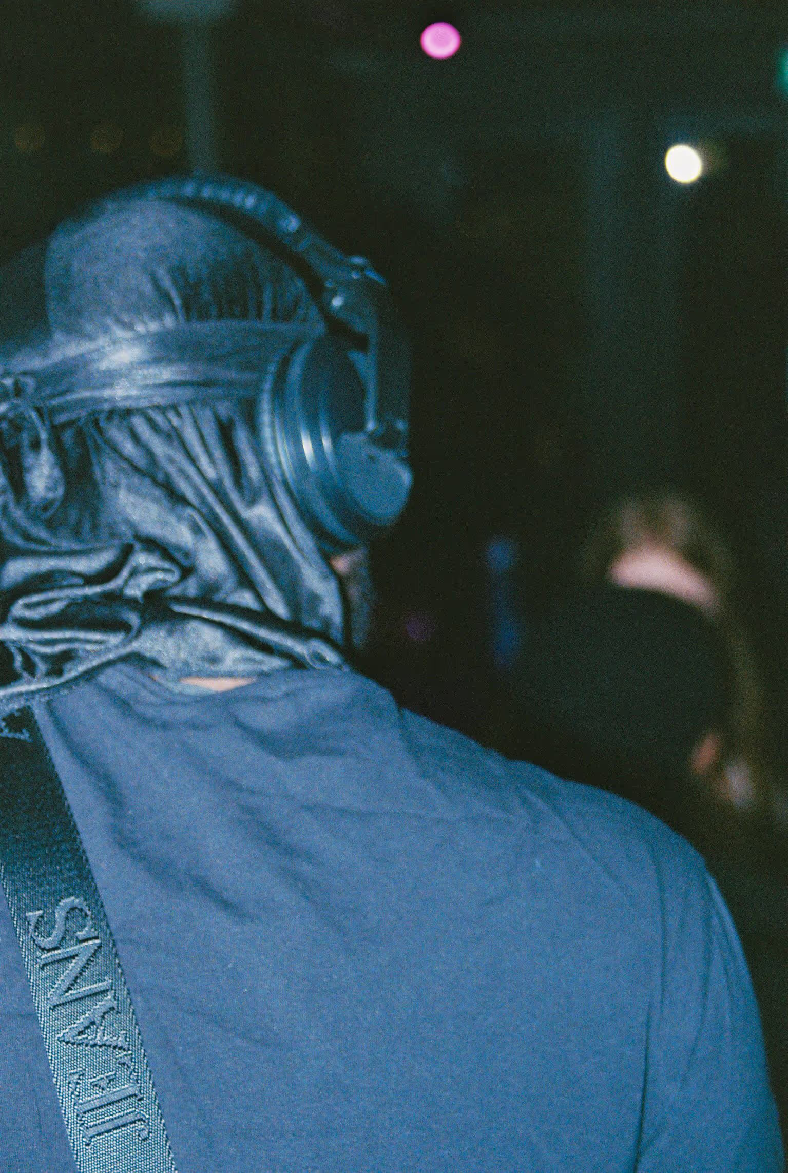A DJ with headphones at the Soirée's launch party in London, UK