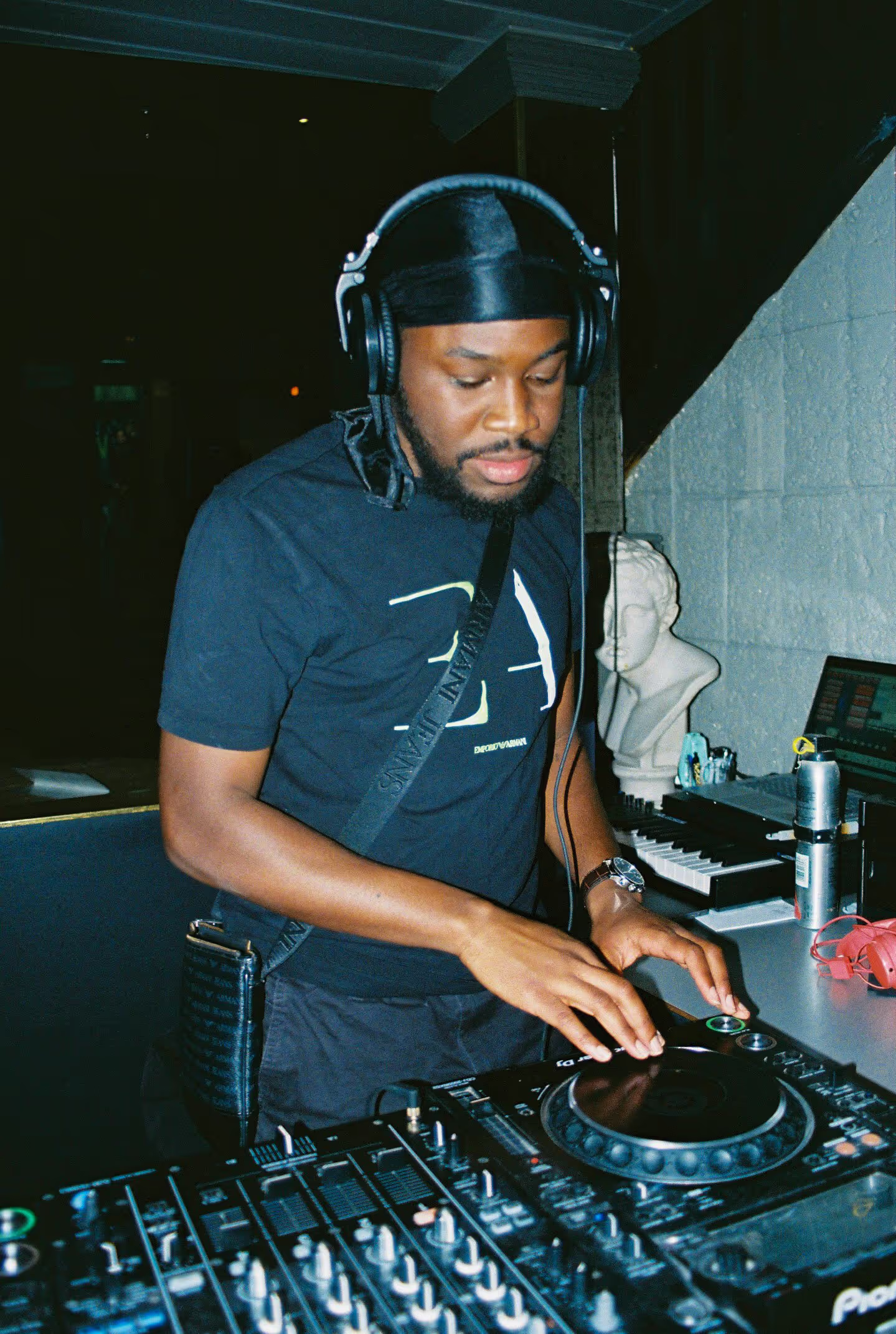 A DJ on his deck performing at the Soirée's launch party in London, UK