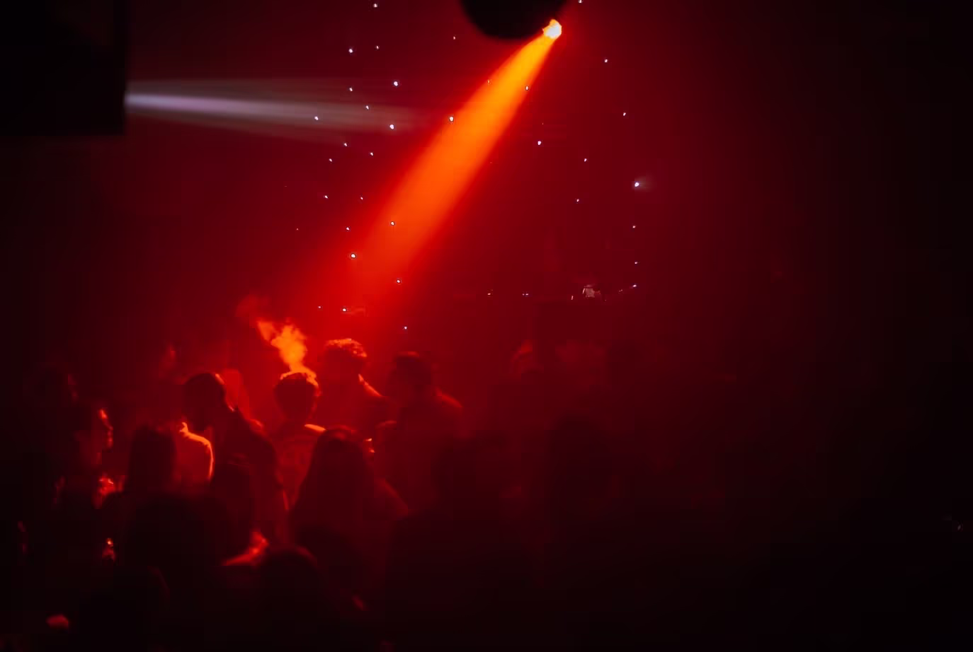 The crowd dancing in red lights at Soirée's "Red Room" party at Proud Cabaret in Brighton, UK