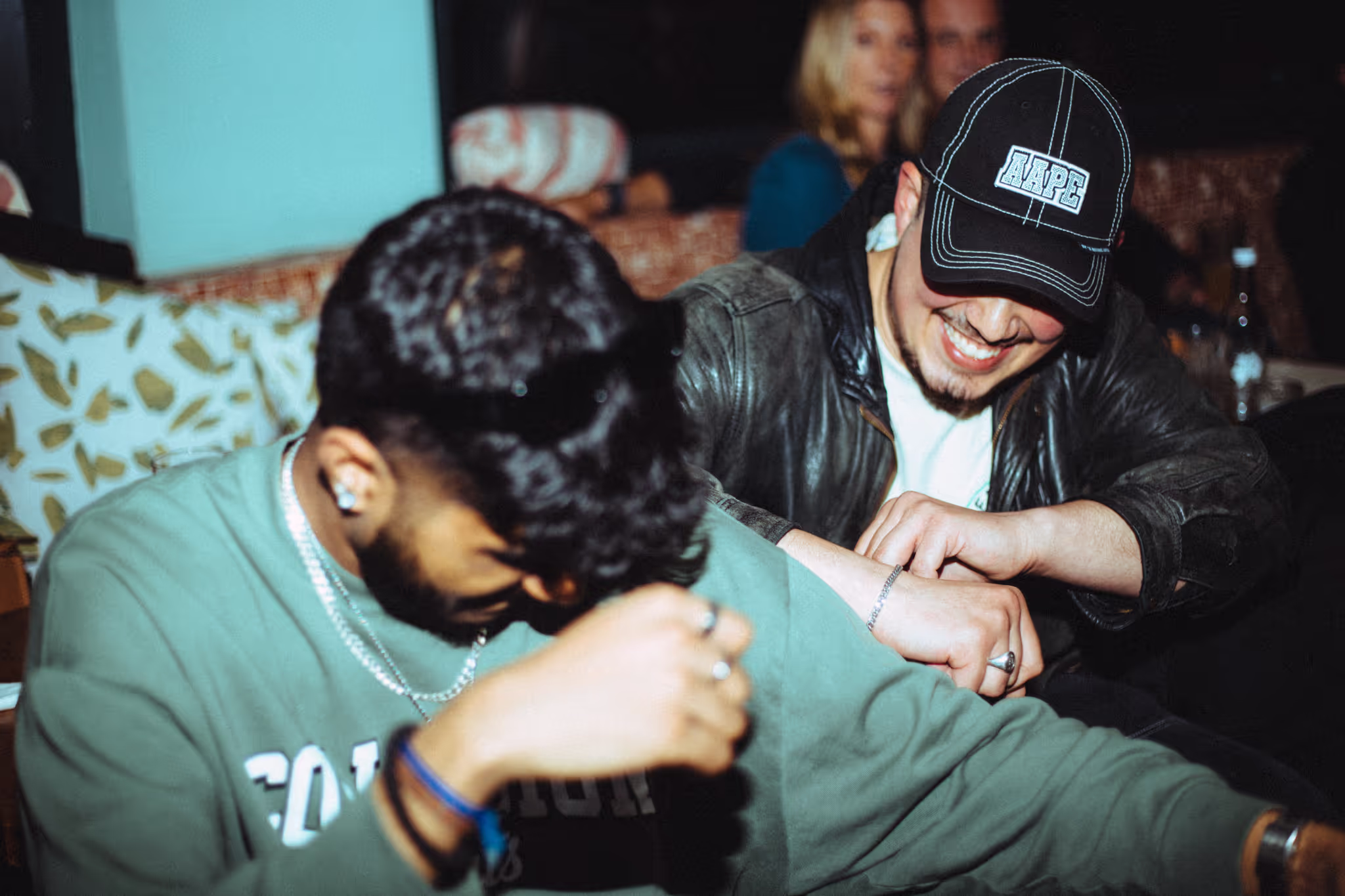 Two friends are laughing and having fun at Soirée's collaboration party with Brighton Beach House in Brighton, UK