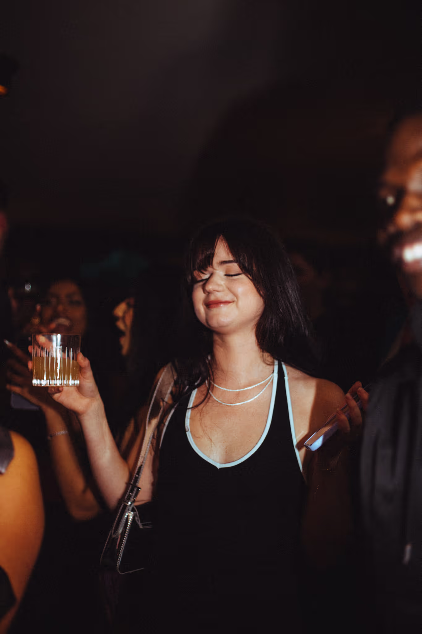 A smiling girl enjoys the part at Soirée's collaboration party with Brighton Beach House in Brighton, UK