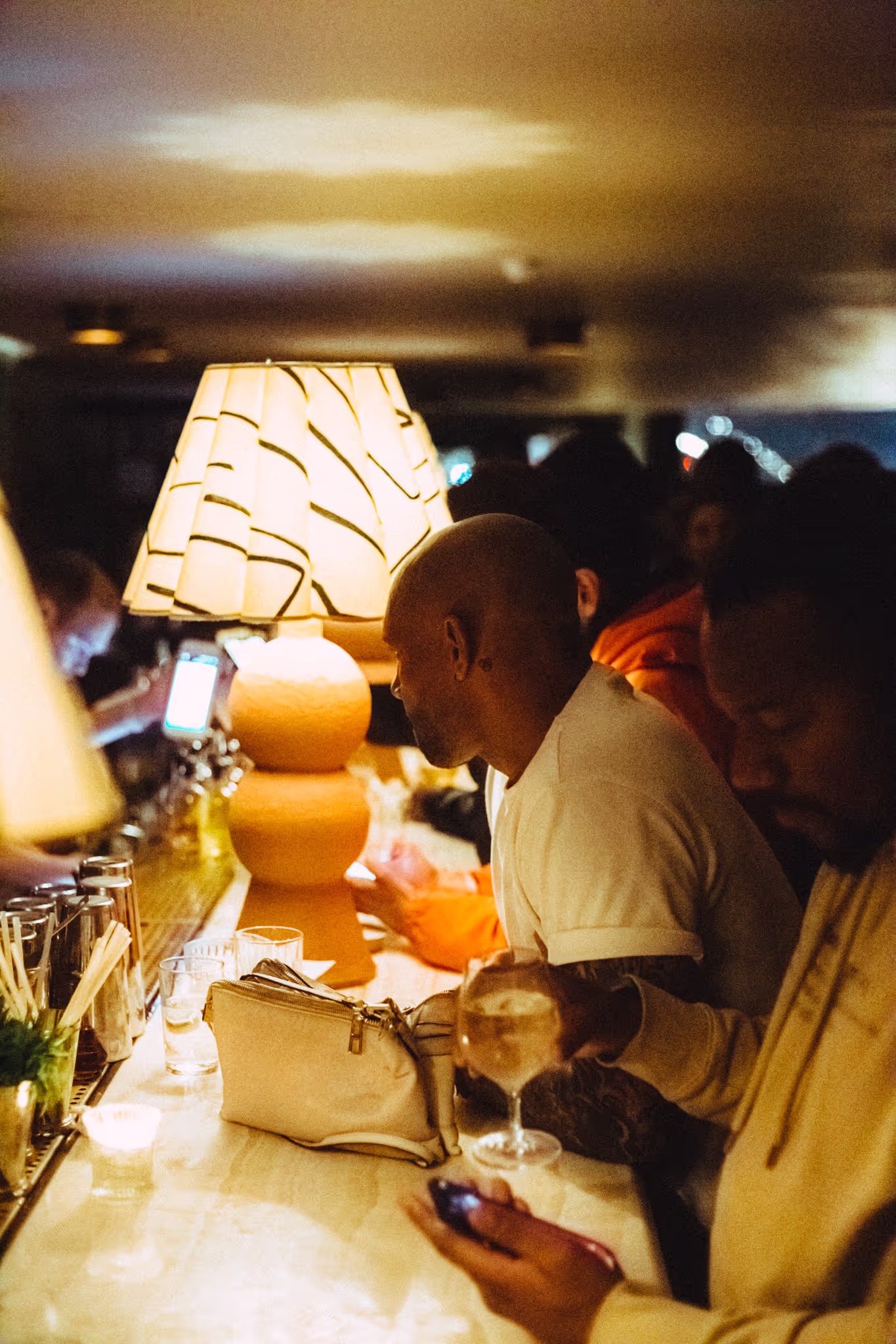 People at the bar have fun at Soirée's collaboration party with Brighton Beach House in Brighton, UK