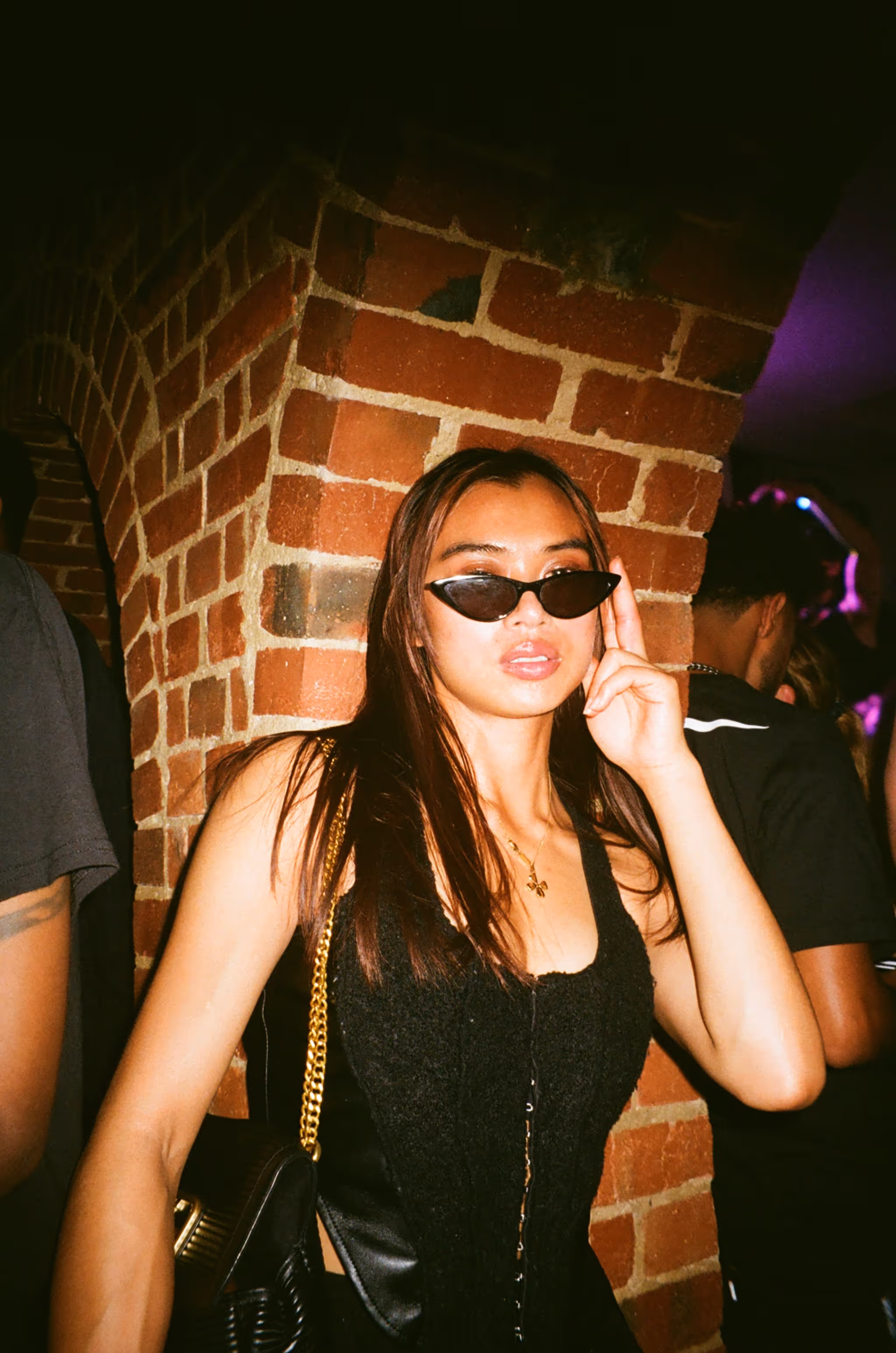 A young woman posing at Soirée's MONOCHROME House Party vol.2, with a dress code ALL BLACK