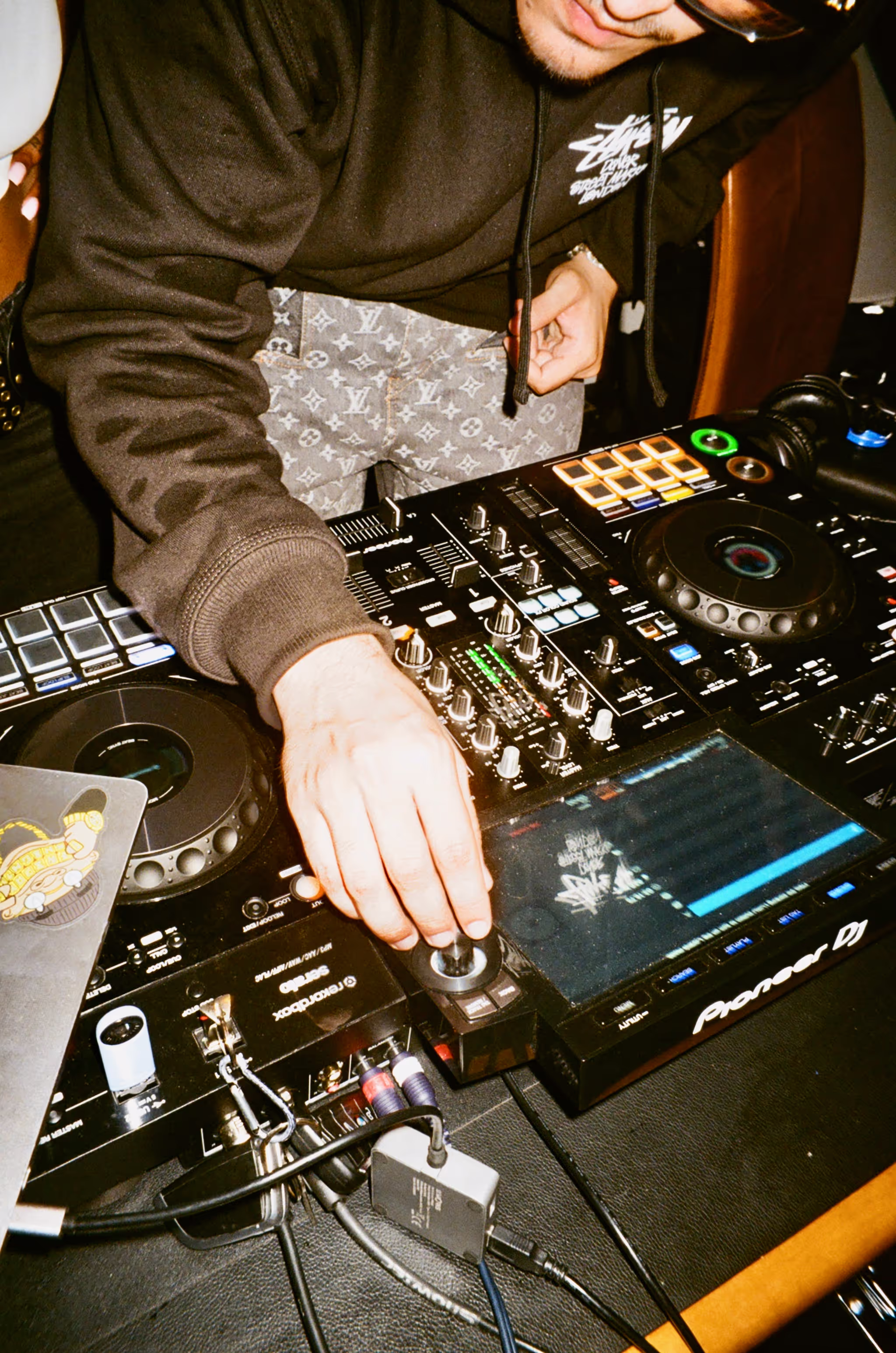 A DJ having fun on his DJ deck at Soirée's MONOCHROME House Party vol.2