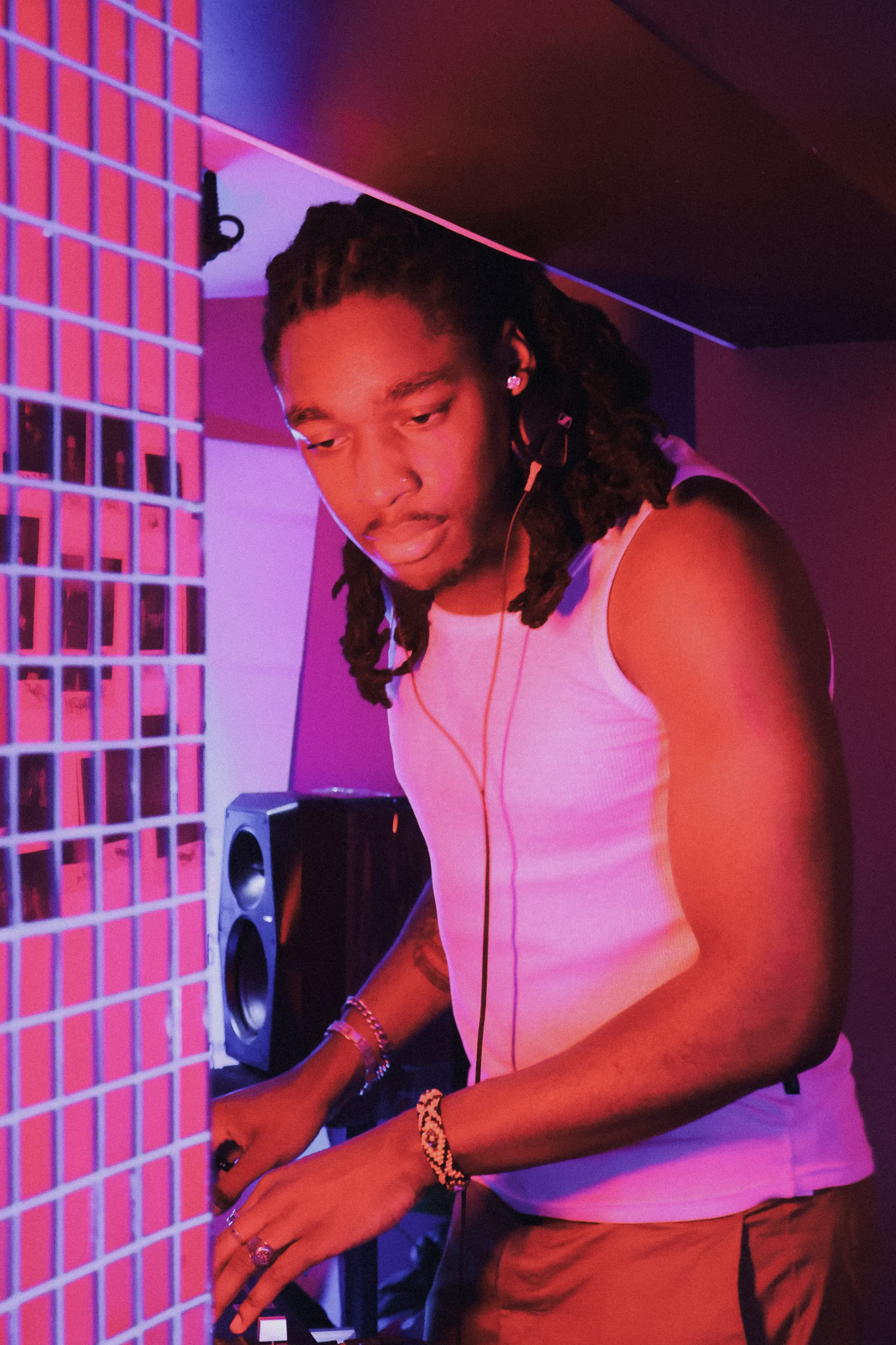 A DJ preparing for his set at Soirée's house party