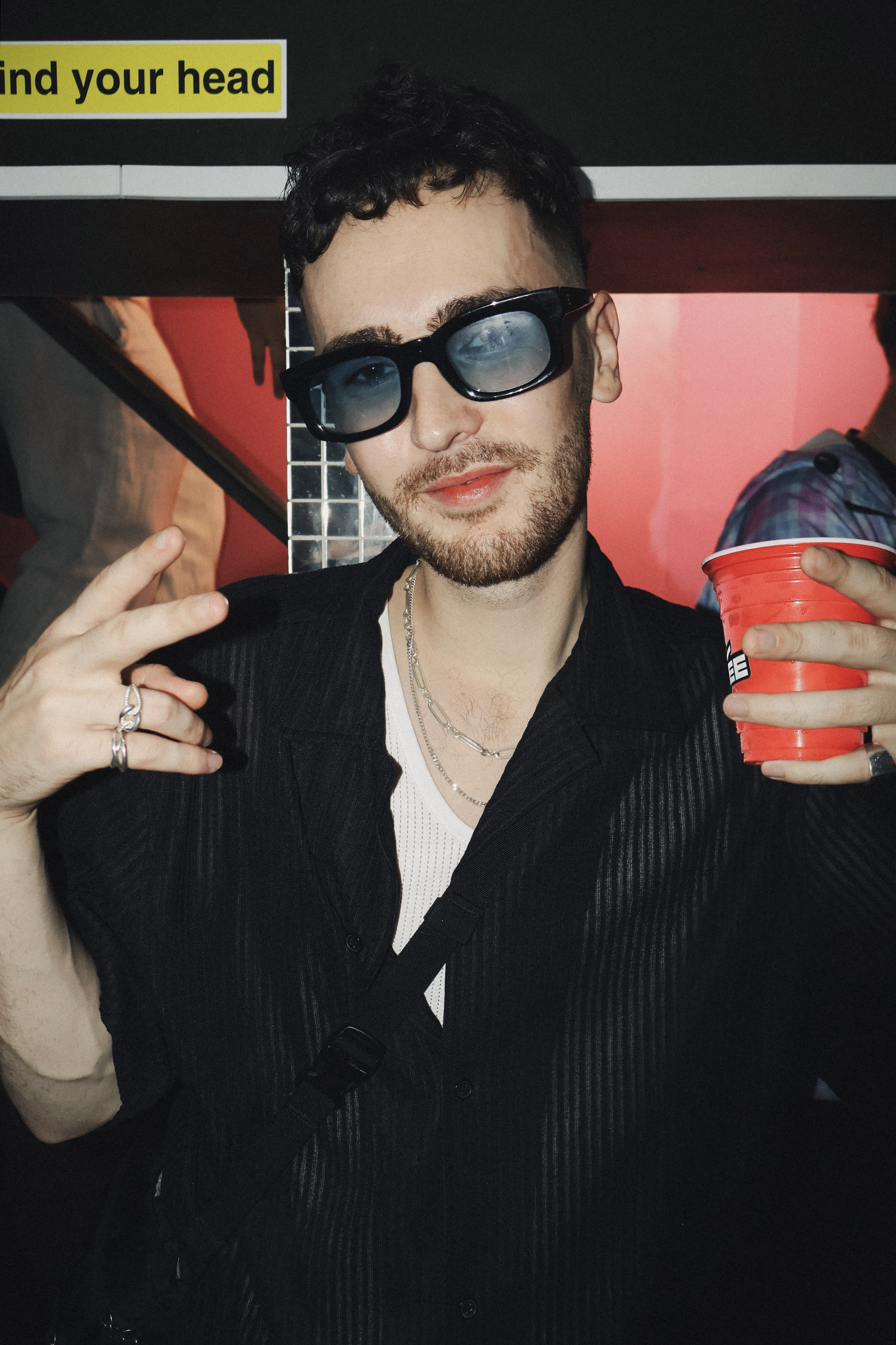 A young man posing at Soirée's house party