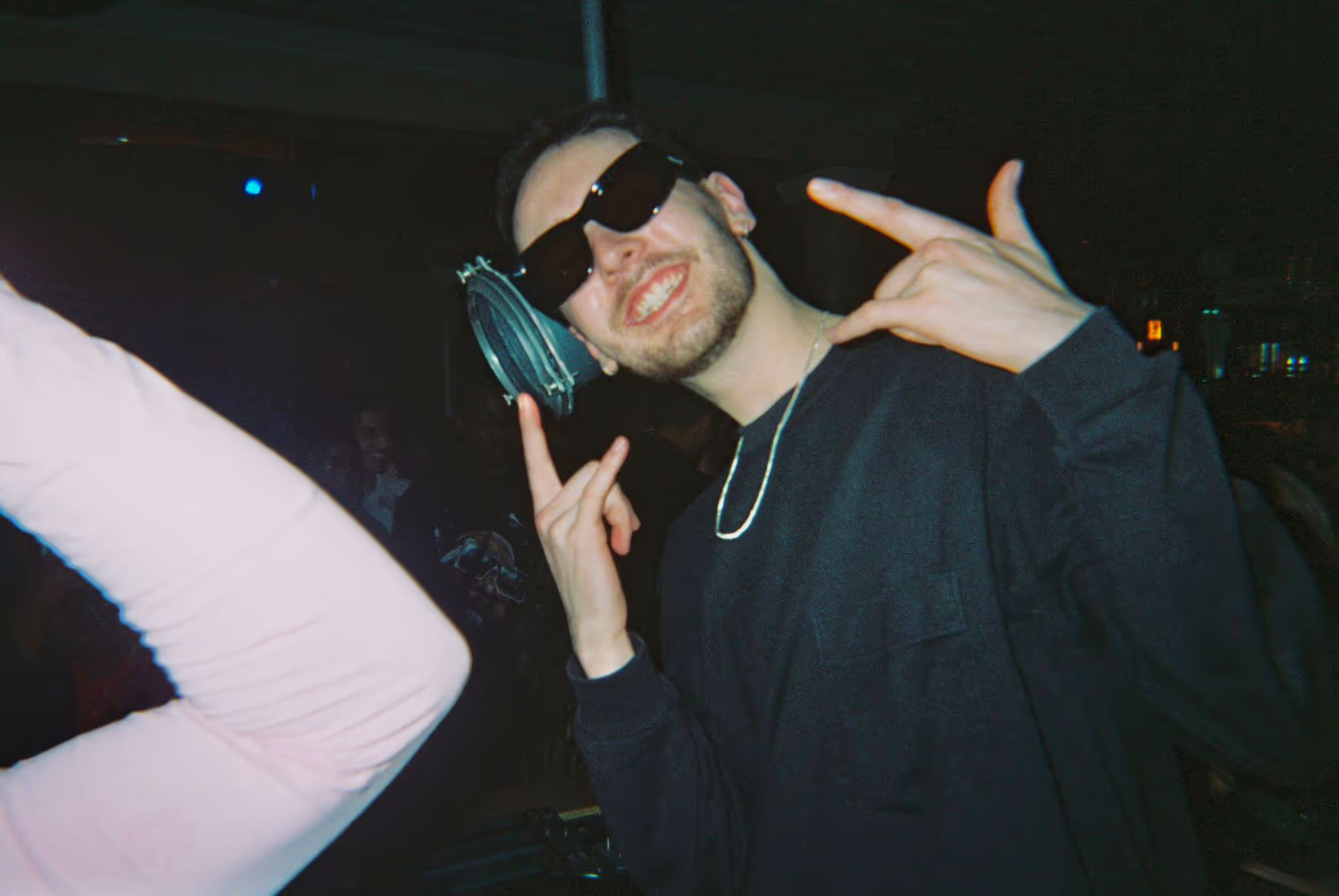 A smiling DJ posing at the Soirée Valentine’s Night event, in London, UK
