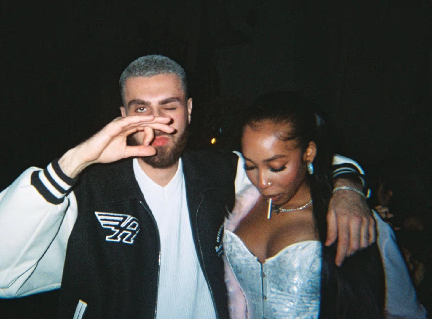 Two young people in modern outfits posing at the Soirée Valentine’s Night event, in London, UK