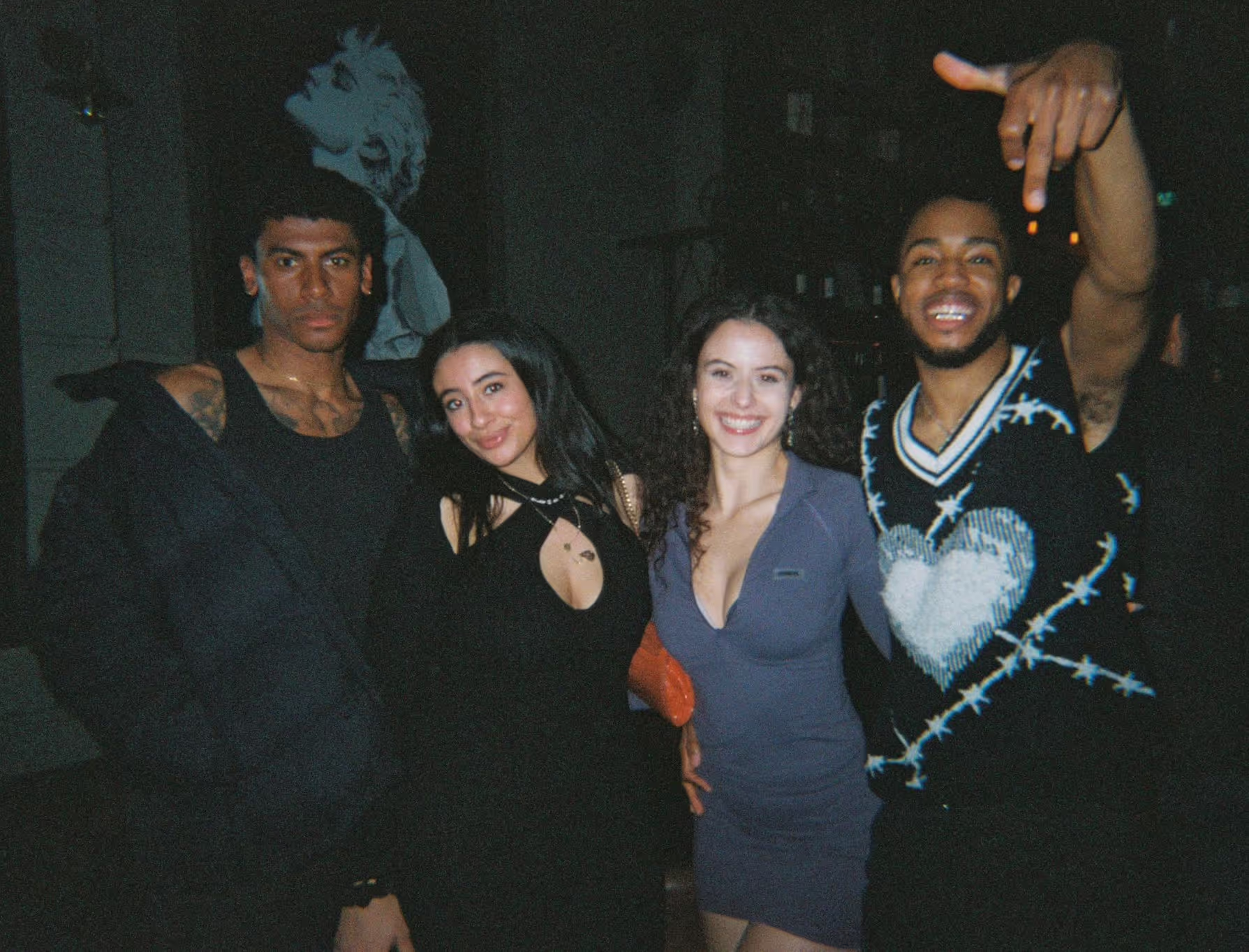 Four smiling friends in a modern outfit posing at the Soirée Valentine’s Night event, in London, UK