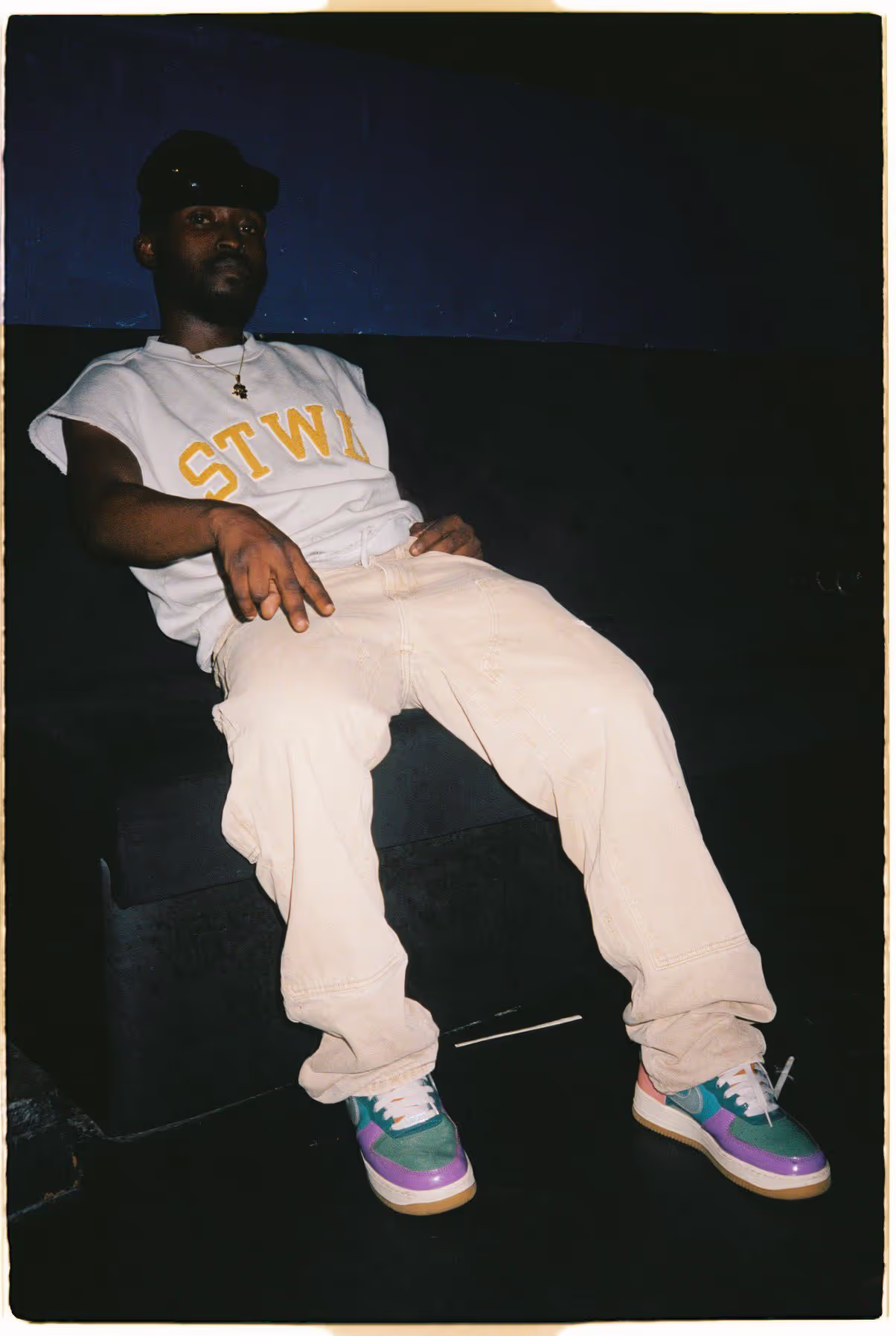 A young man relaxing in an armchair at PARIS FASHION WEEK SS24, an afterparty hosted by the Soirée