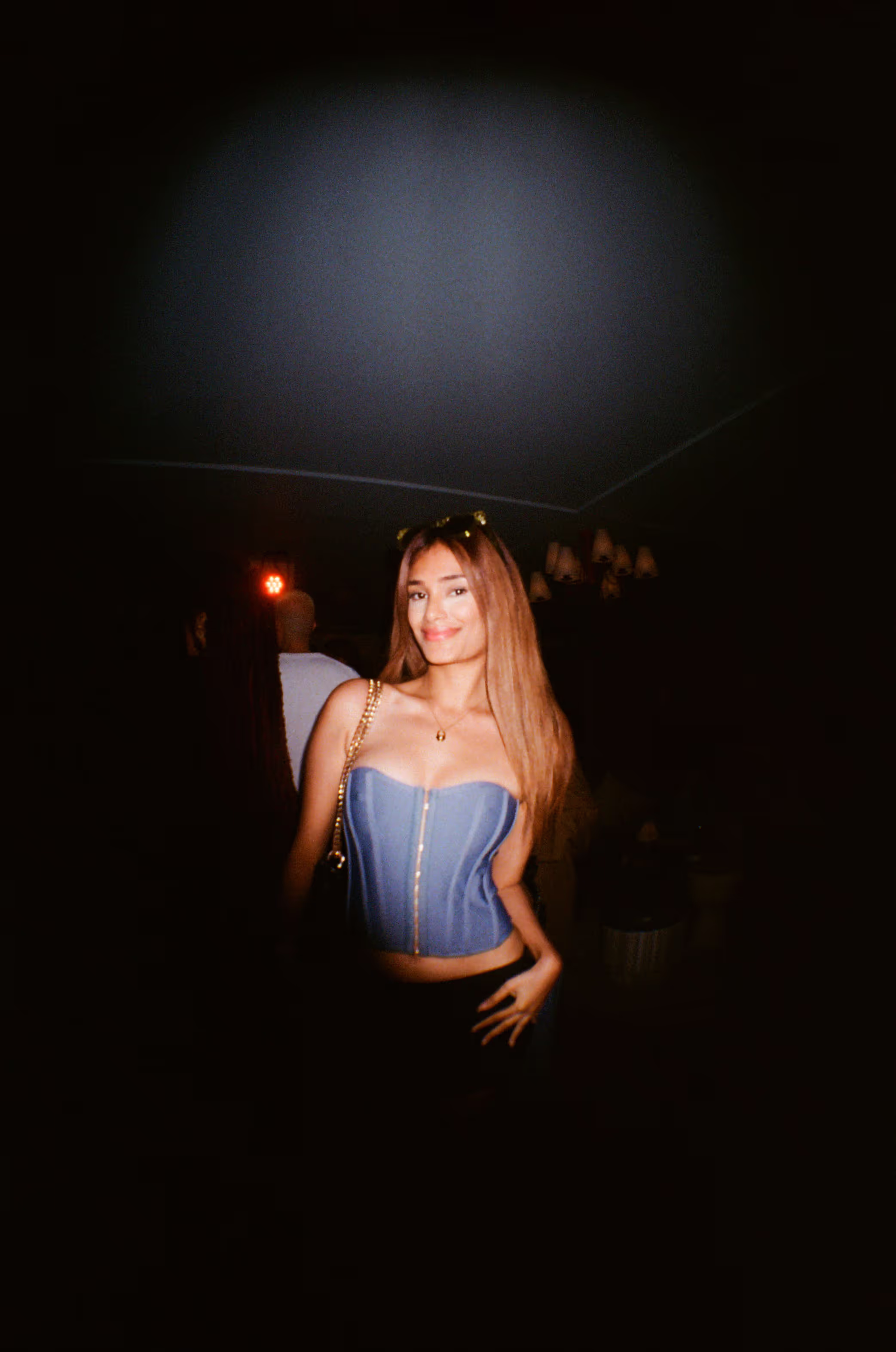 A young woman in a modern outfit having fun and posing at the Soirée art show and music event at Soho Brighton Beach House, Brighton, UK