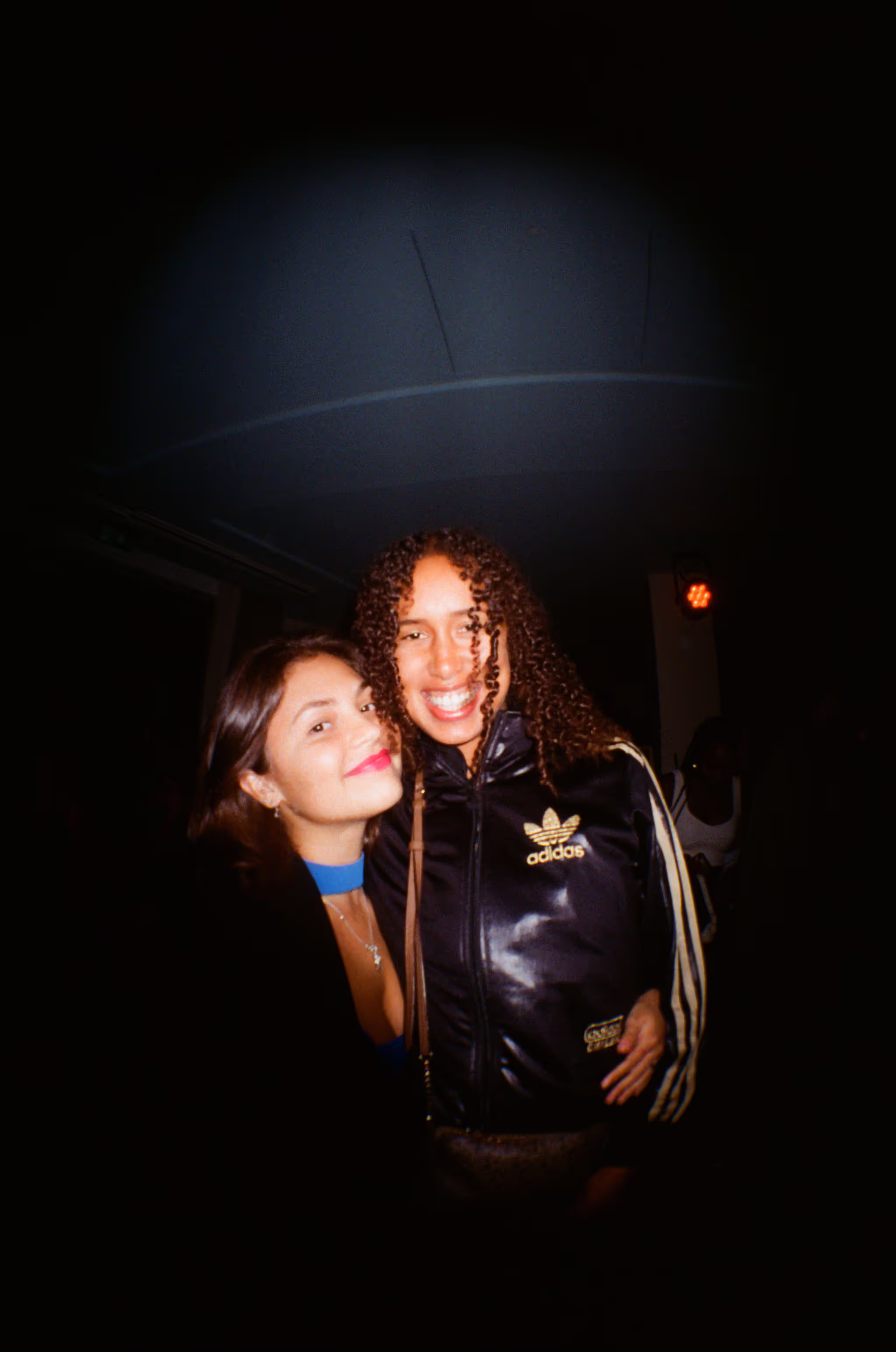 Two friends having fun at the Soirée art show and music event at Soho Brighton Beach House, Brighton, UK