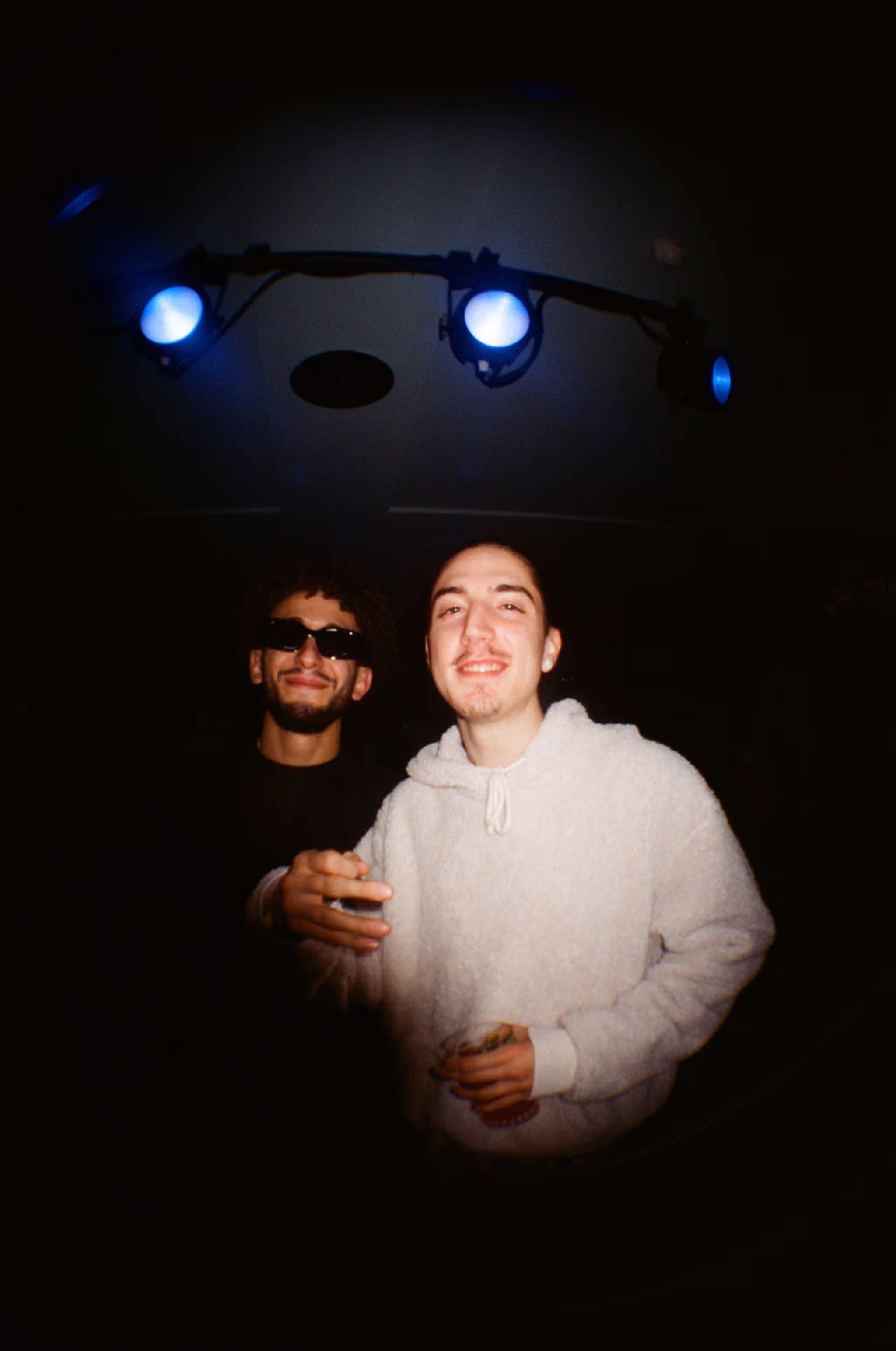 Two friends having fun and posing at the Soirée art show and music event at Soho Brighton Beach House, Brighton, UK