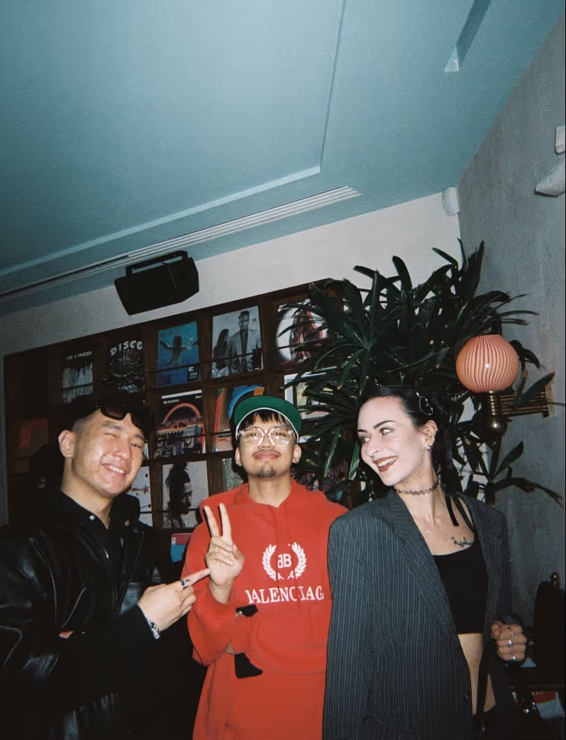 Three friends smiling and posing at the Soirée's event in Brighton, UK
