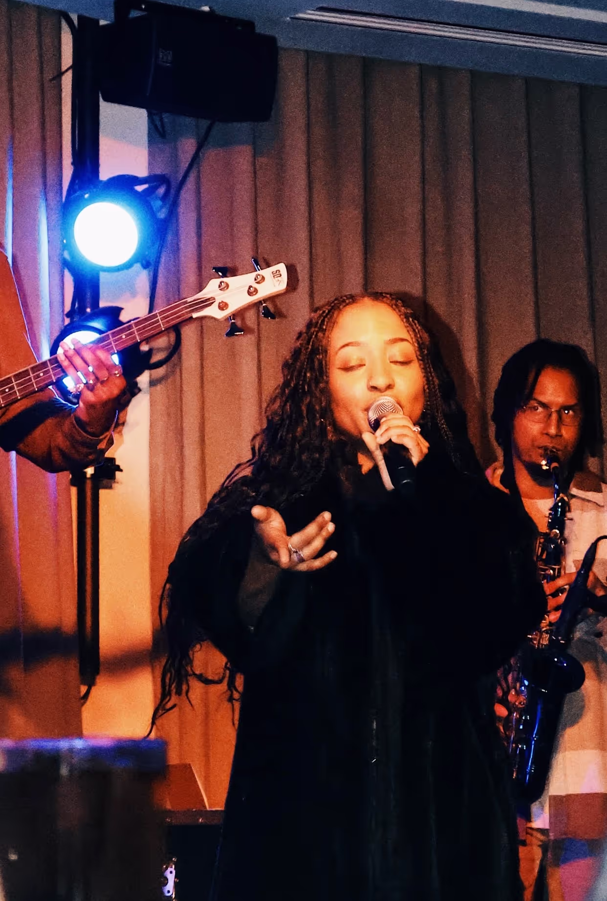 A singer performing with her band at the Soirée's event in Brighton, UK