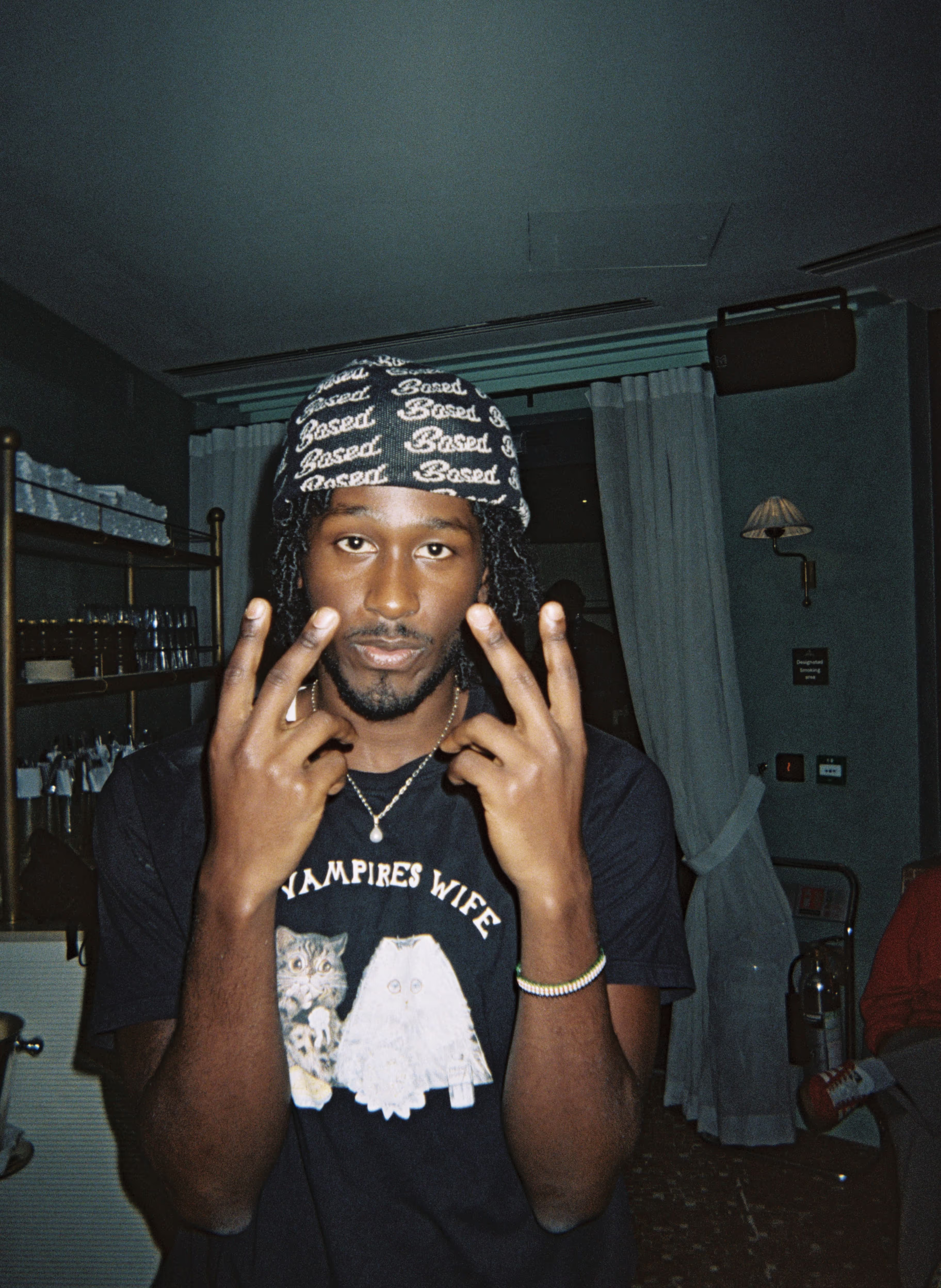 A man posing in the lobby at the Soirée's event in Brighton, UK